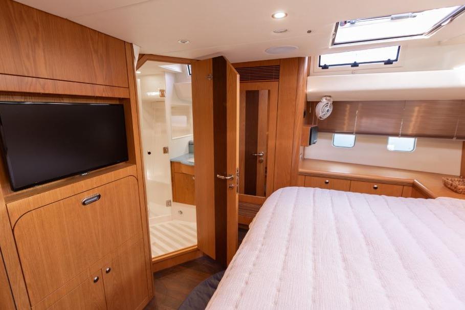 Luxurious interior of 2015 Discovery 58 yacht with wood finish and modern amenities.