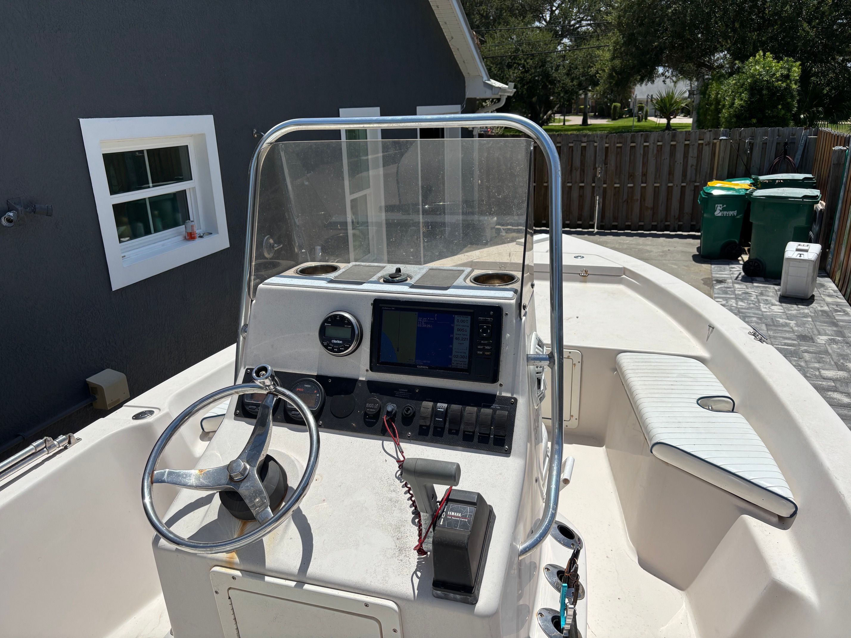 The image shows the cockpit of a 2003 Pathfinder 1900T boat with steering and electronics.