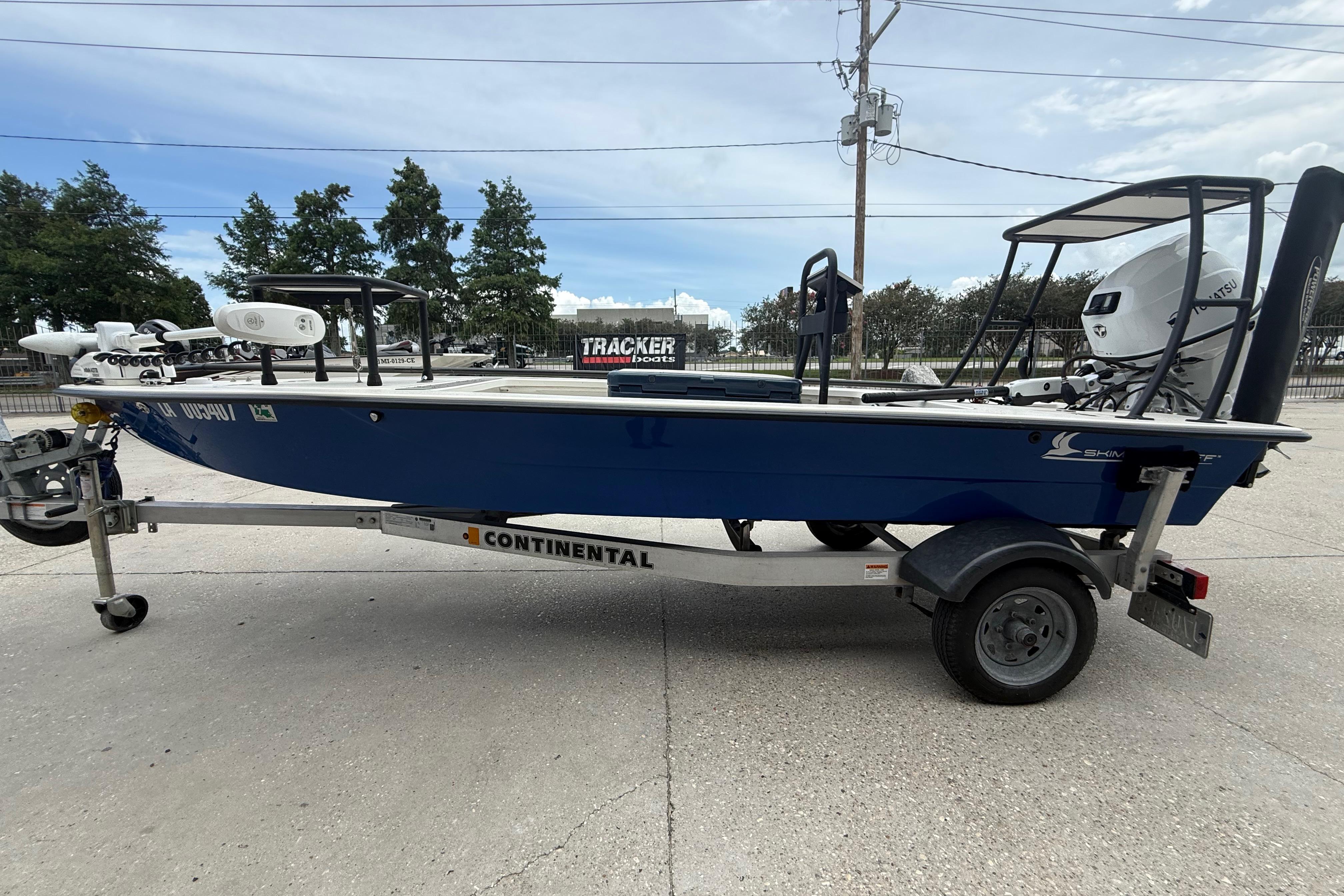2020 Skimmer Skiff 14 boat on Continental trailer, parked outdoors.