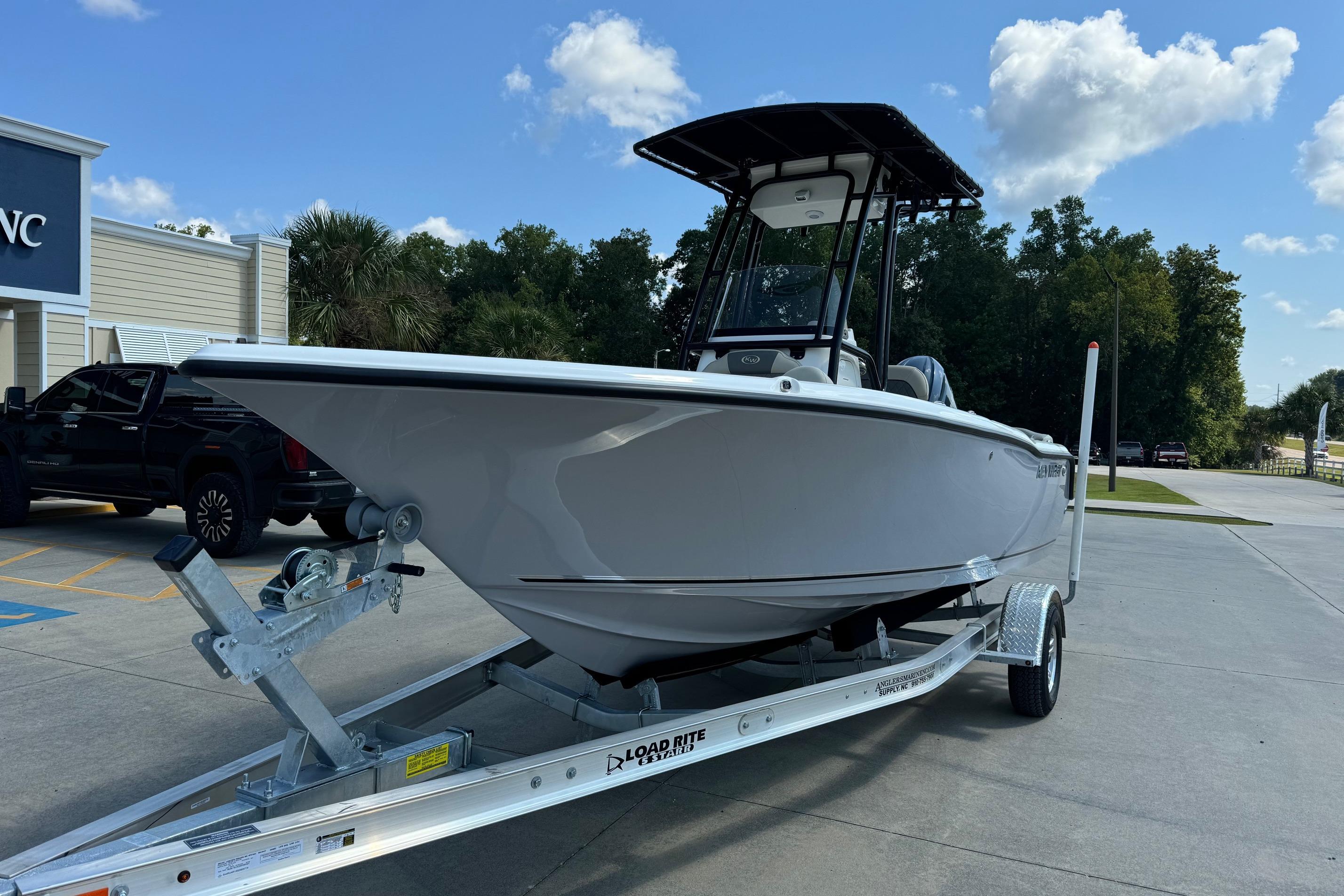 2025 Key West 203 FS boat on trailer, parked outdoors under blue sky.