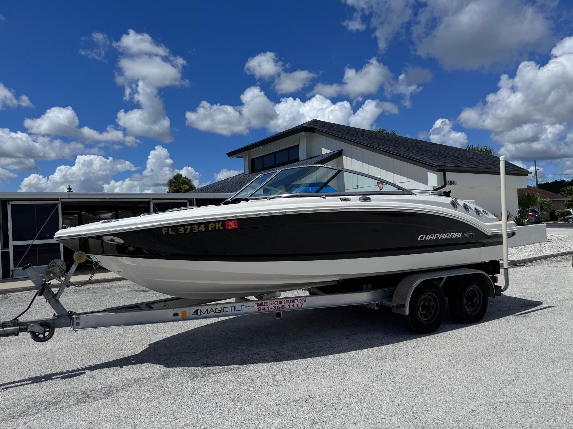 2013 Chaparral 206 SSi on a trailer, parked in front of a building.