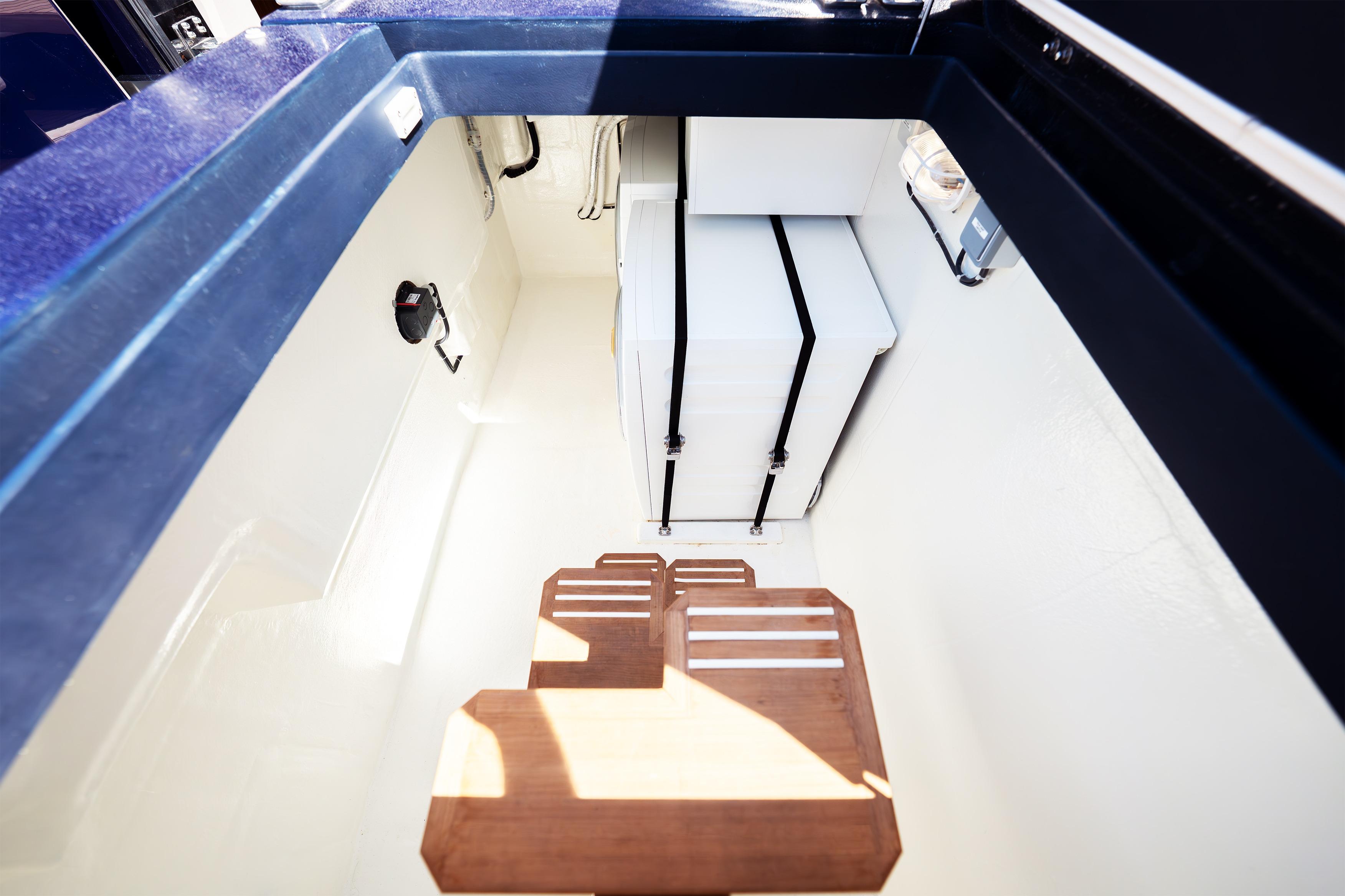 Interior view of 2024 Sunreef 60 Eco yacht, featuring sleek storage and wooden steps.