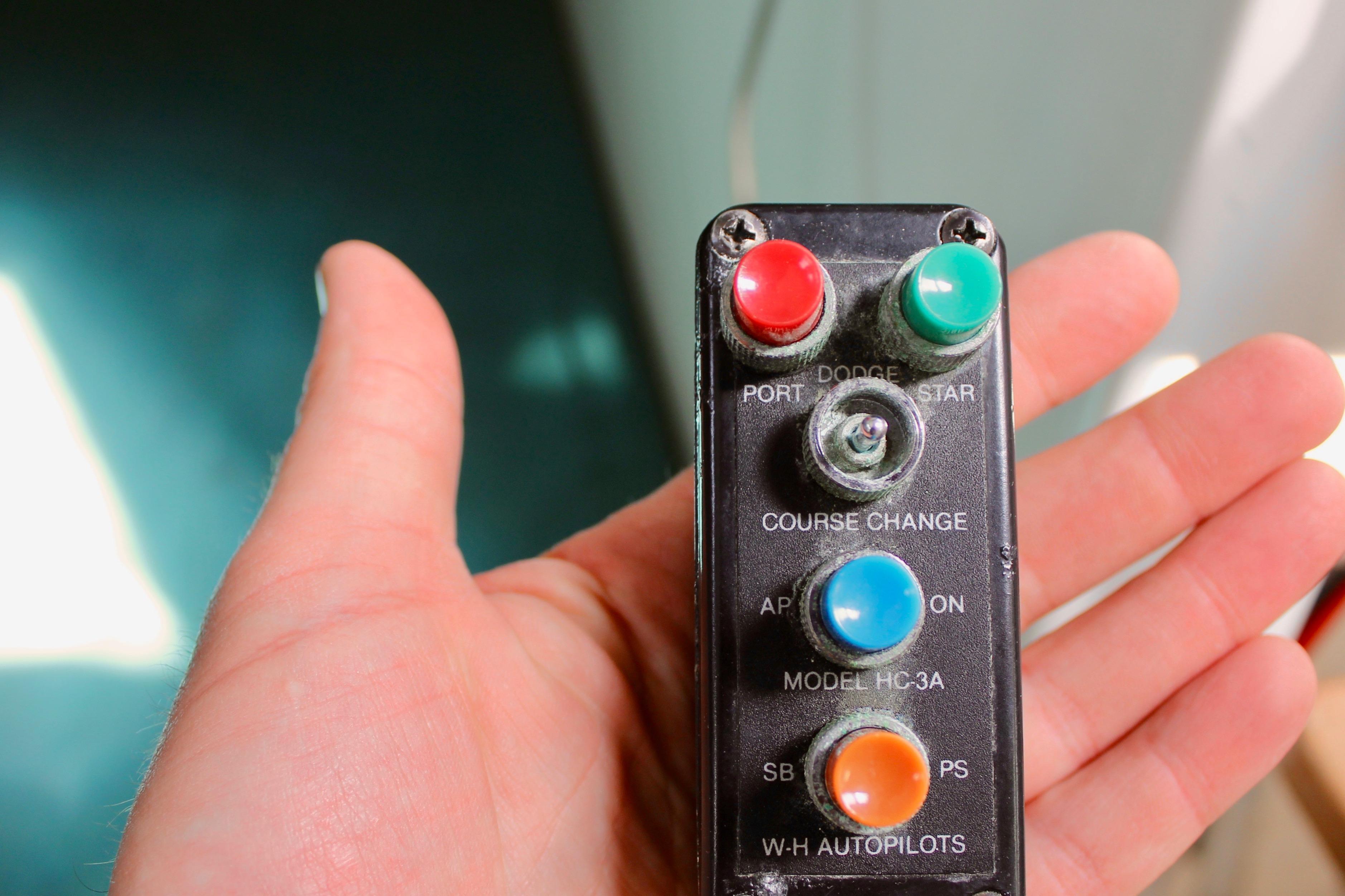 Hand holding vintage Freya 39 autopilot control panel with colorful buttons, model HC-3A, from 1993.