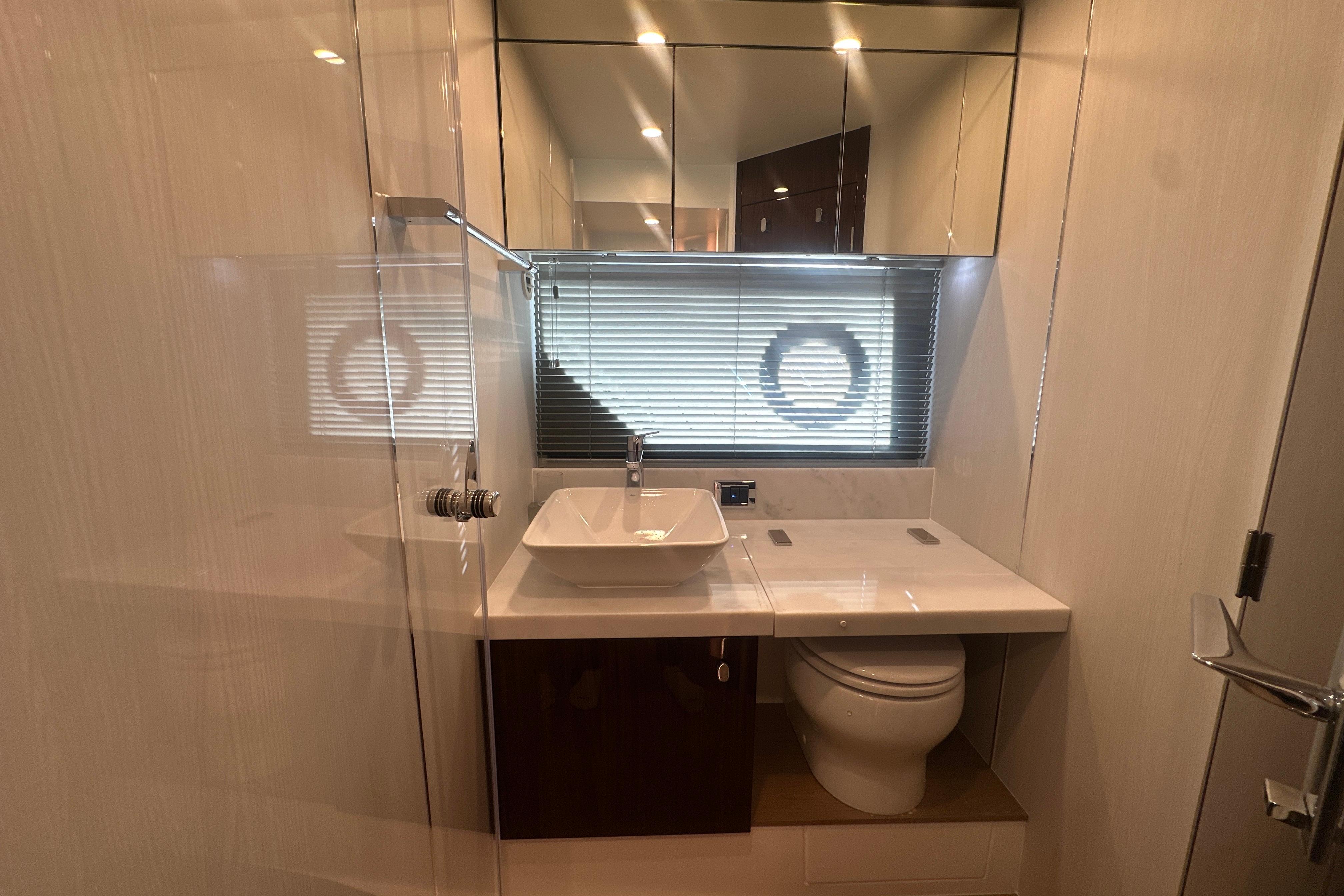 Luxurious bathroom interior of 2024 Fairline Squadron 50 yacht, featuring modern fixtures and elegant design.