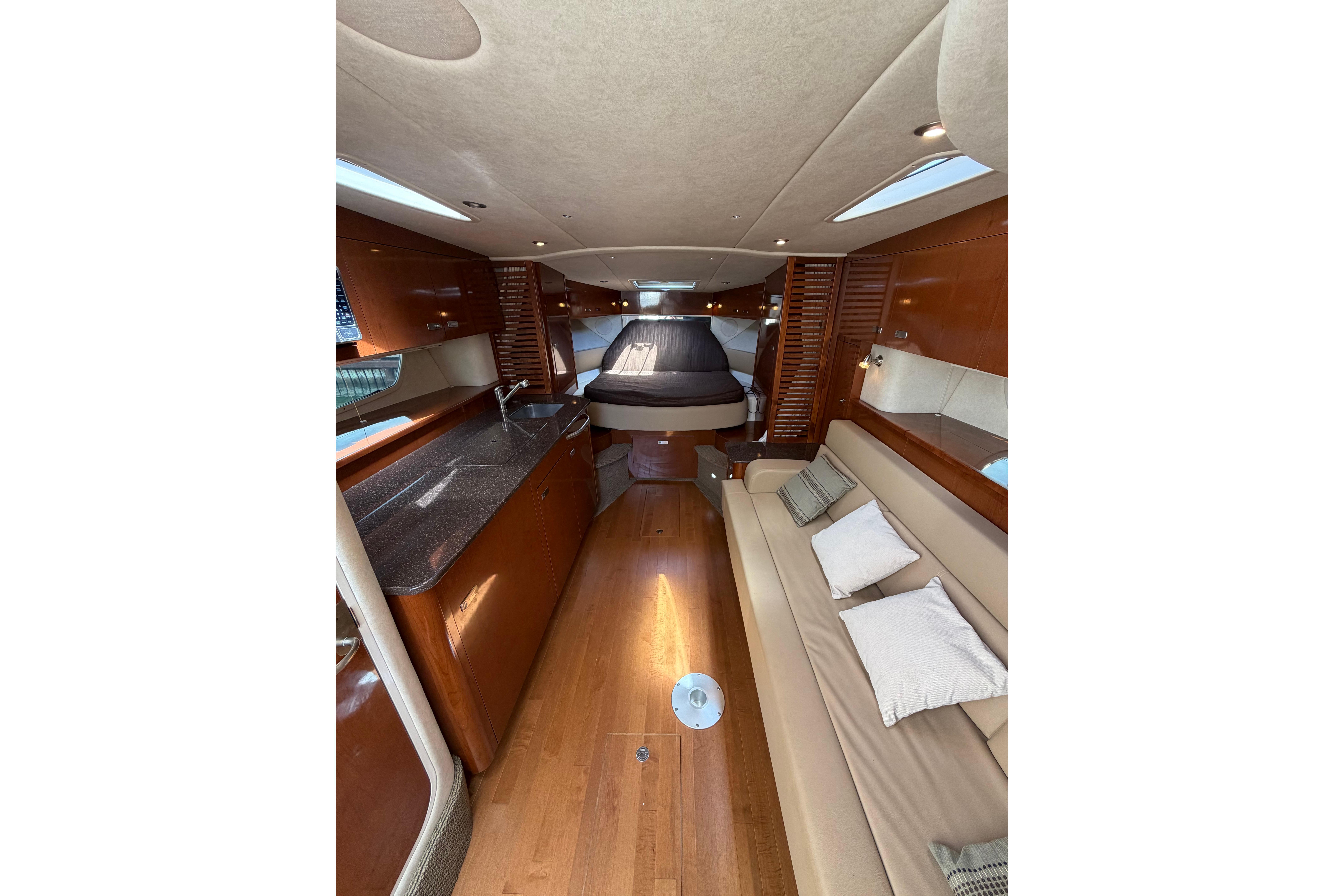 Luxurious interior of 2012 Sea Ray Sundancer 370 yacht with elegant wood finishes.