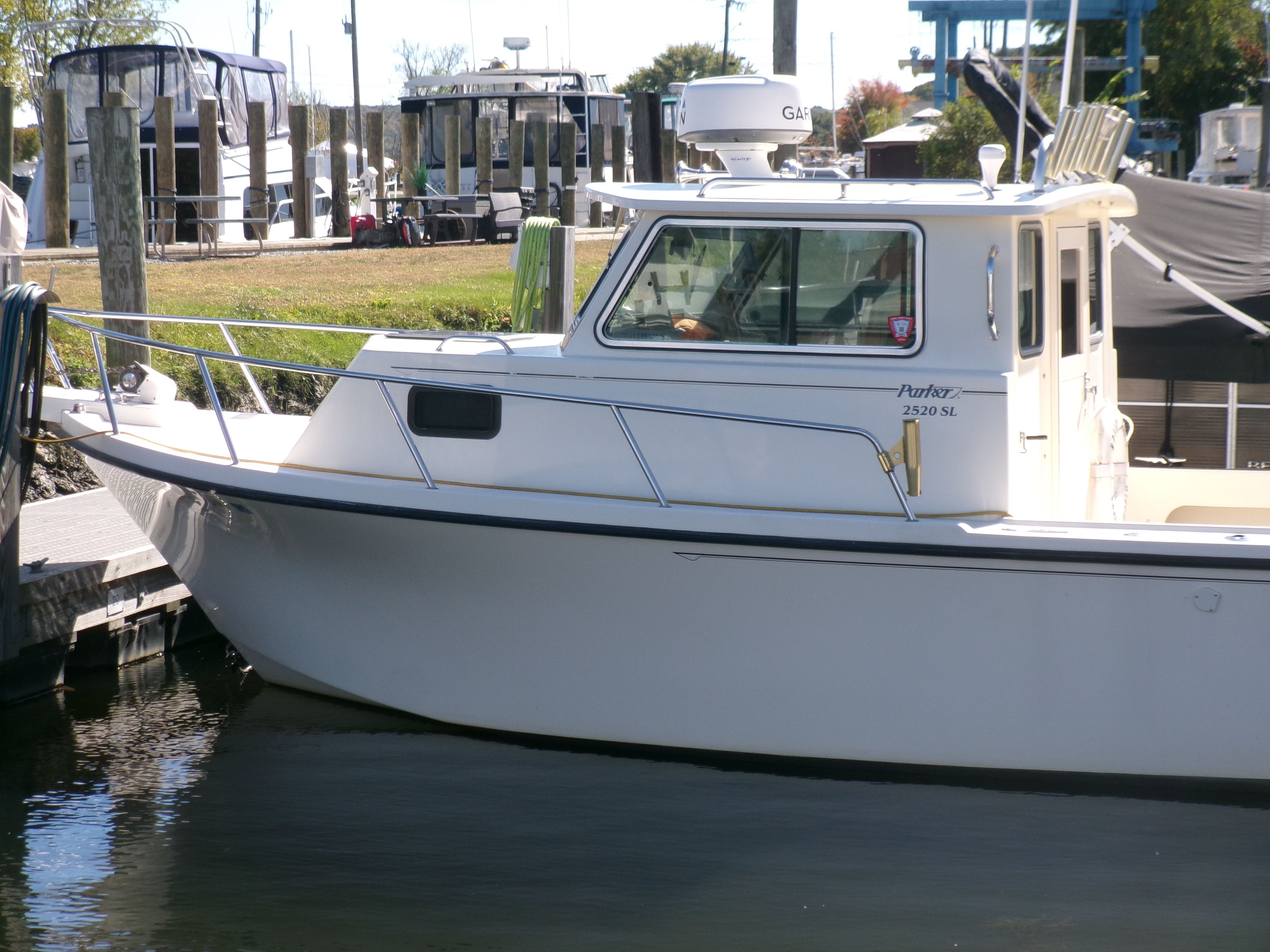 A 2007 Parker 2520 XL Sport Cabin boat docked at a marina.