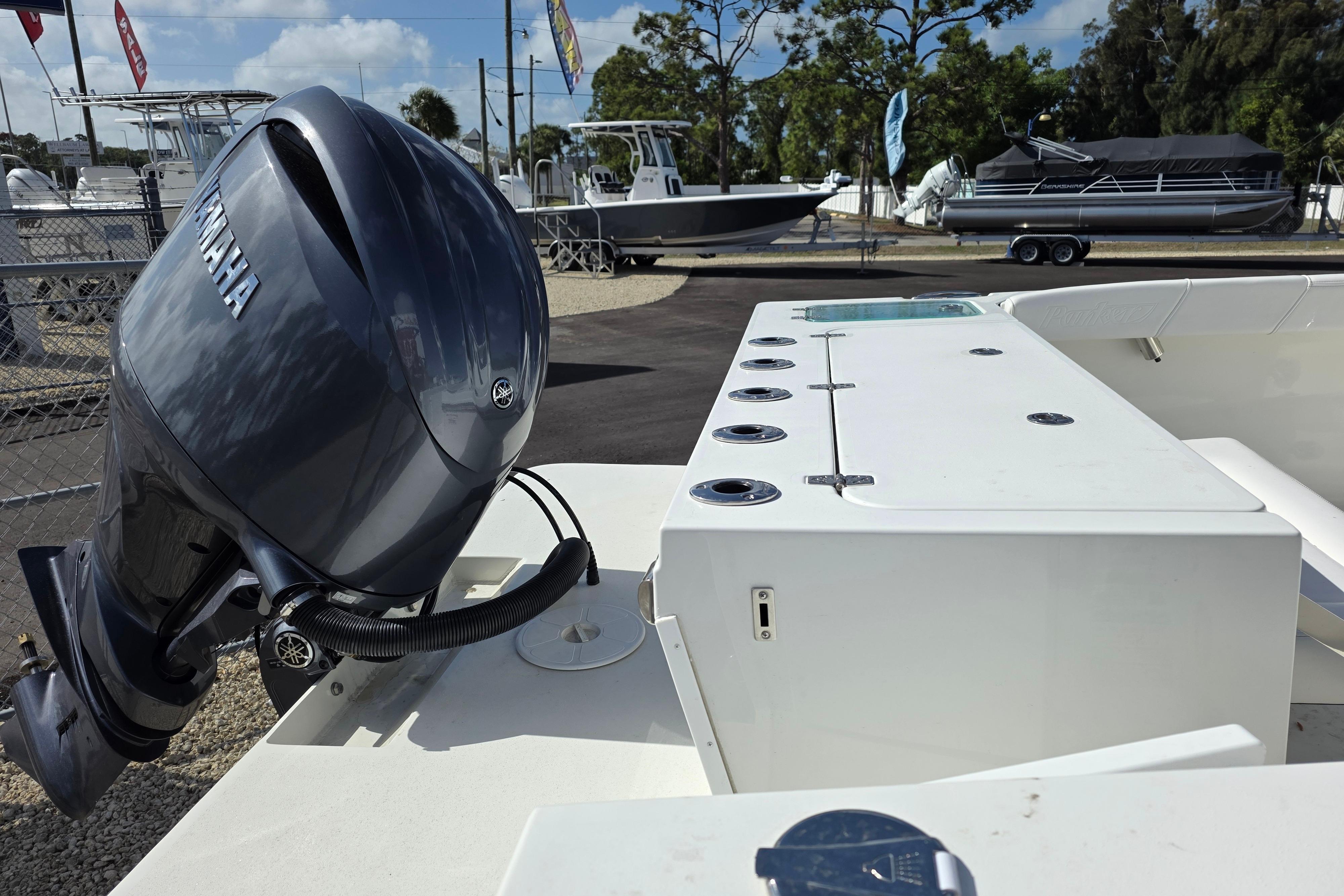 2026 Parker 227 Explorer boat with Yamaha outboard motor, docked at a marina.