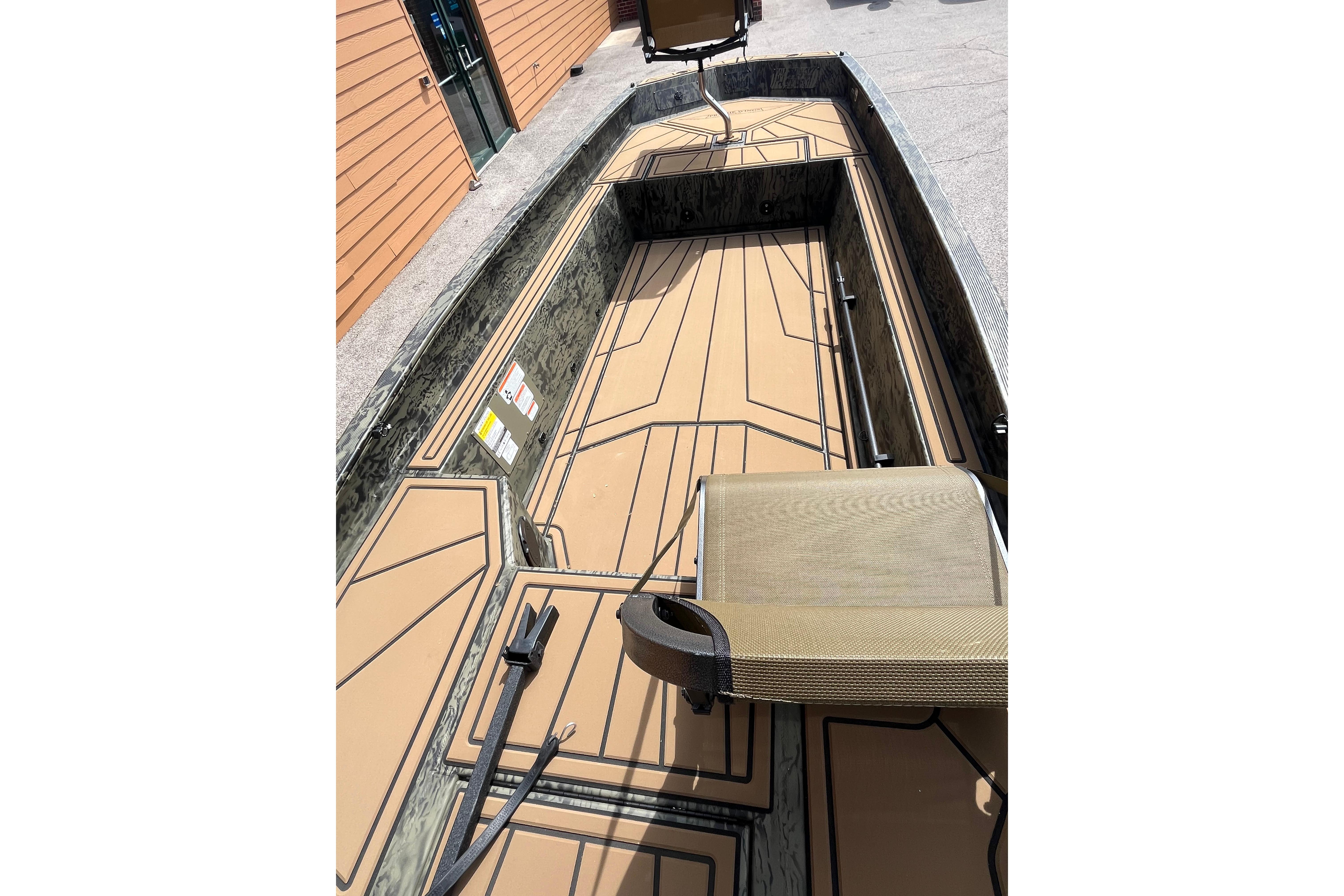 2026 Tracker Grizzly 1650 T Prairie Wings Edition boat interior with seating and deck design.