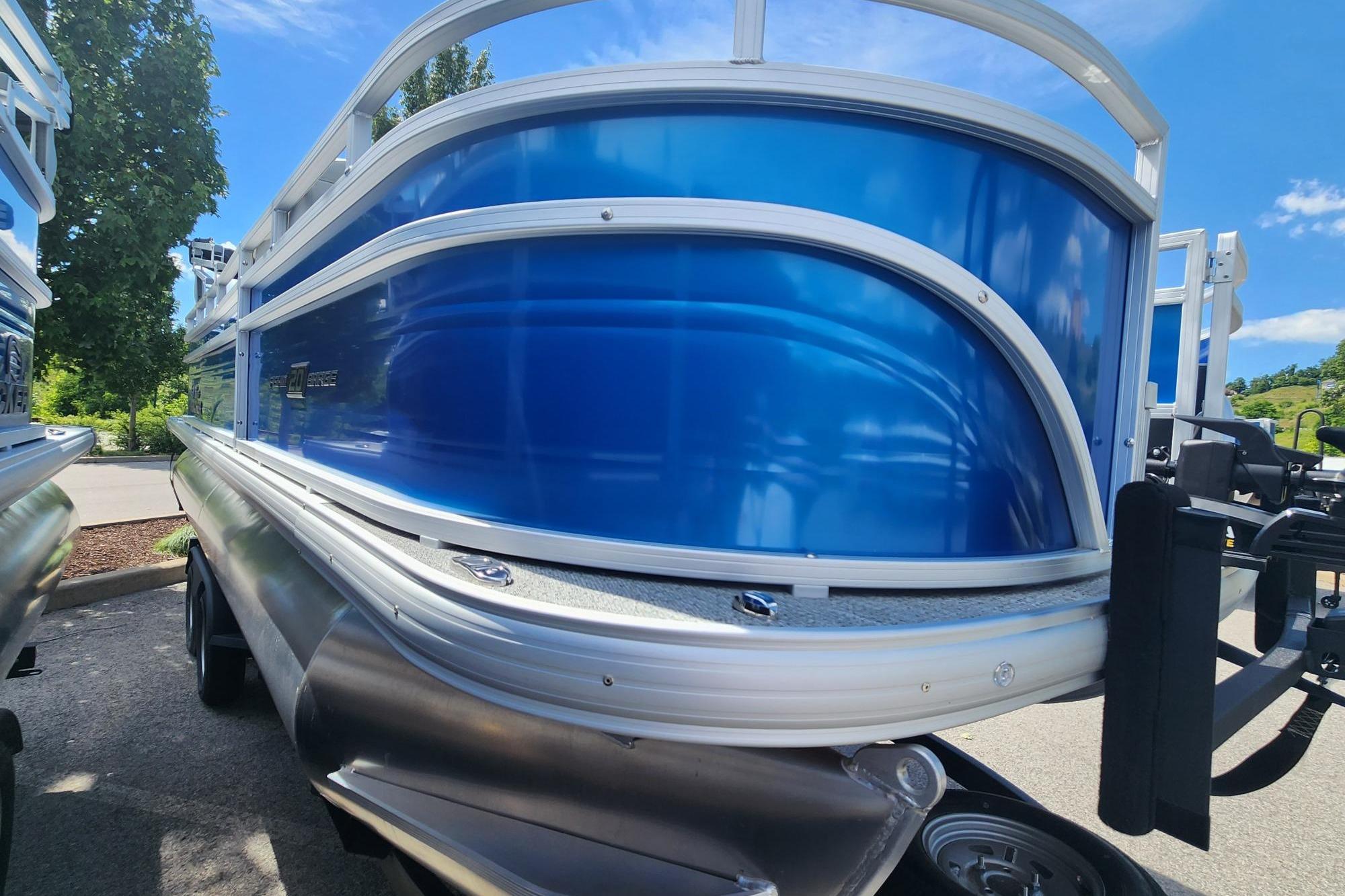 2026 Sun Tracker Fishin' Barge 20 DLX pontoon boat with sleek blue exterior.