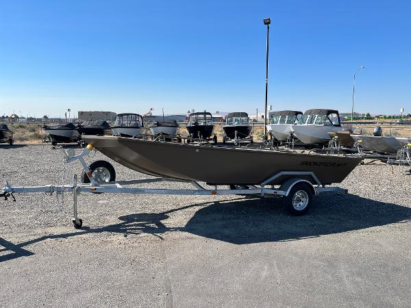 2024 Smoker Craft 1660 Sportsman Pro boat on a trailer in a dealership lot.