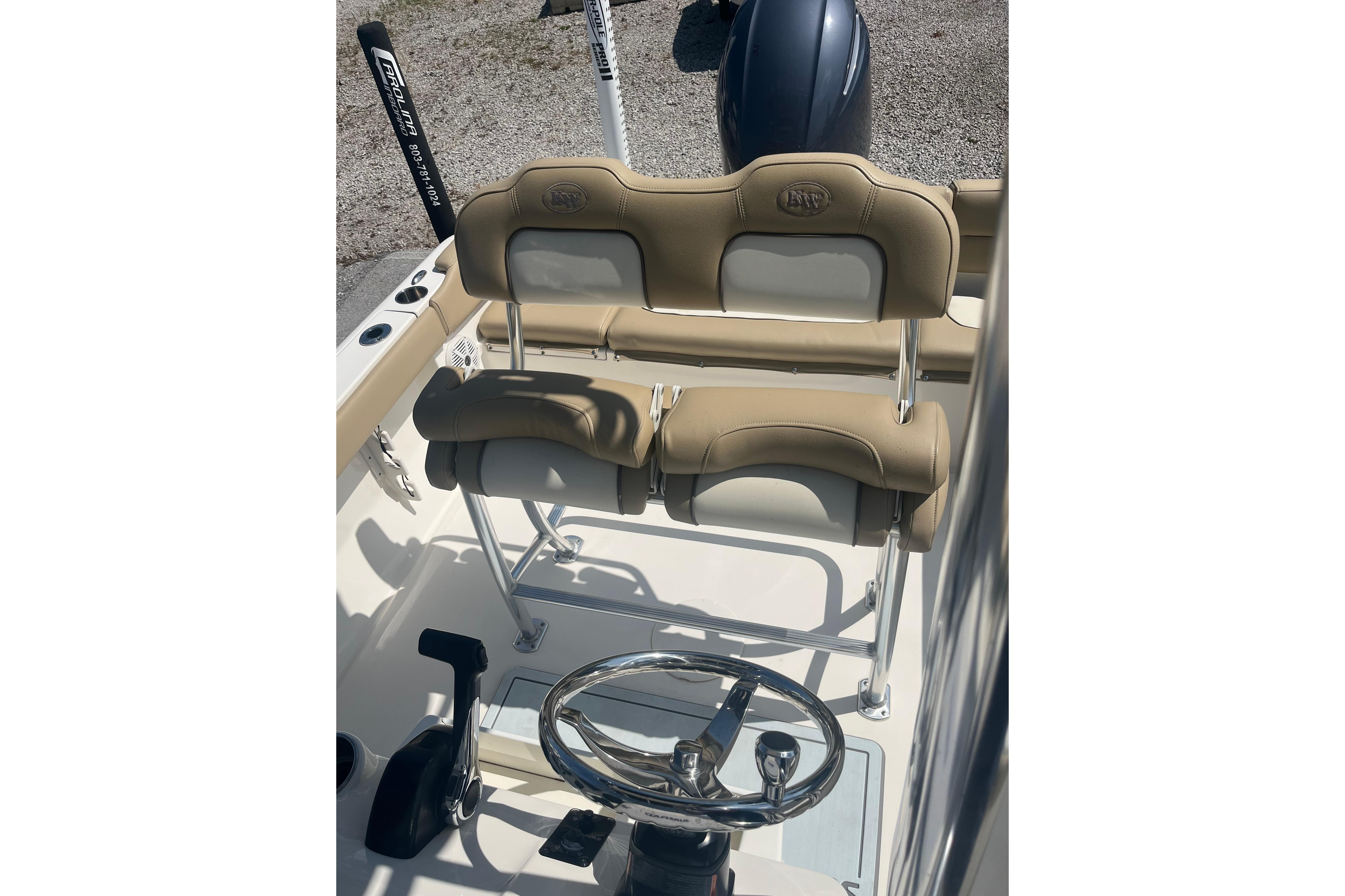 2017 Key West 203 FS boat interior with steering wheel and cushioned seating.