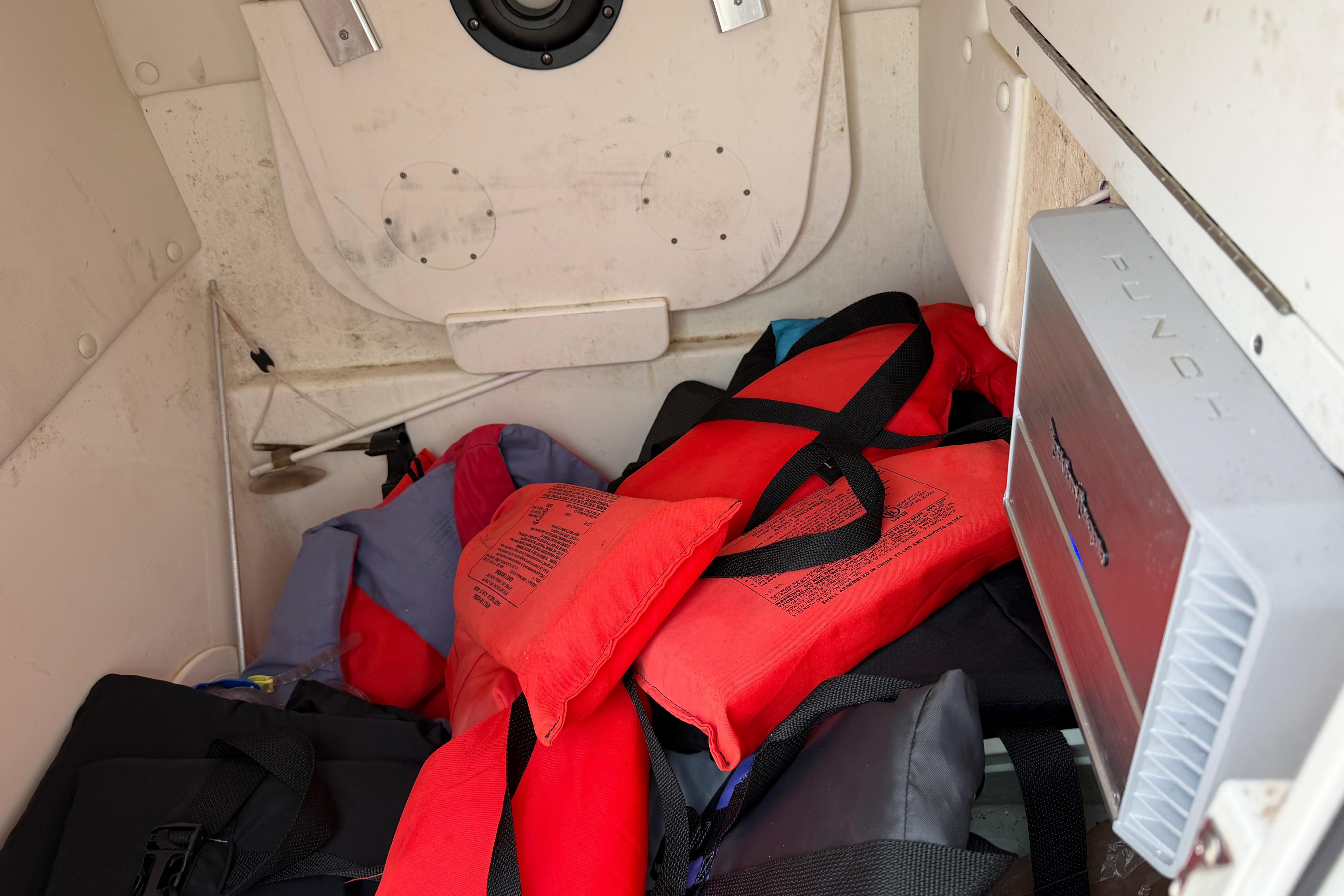 Storage compartment of 2019 World Cat 230 DC with life jackets and equipment.