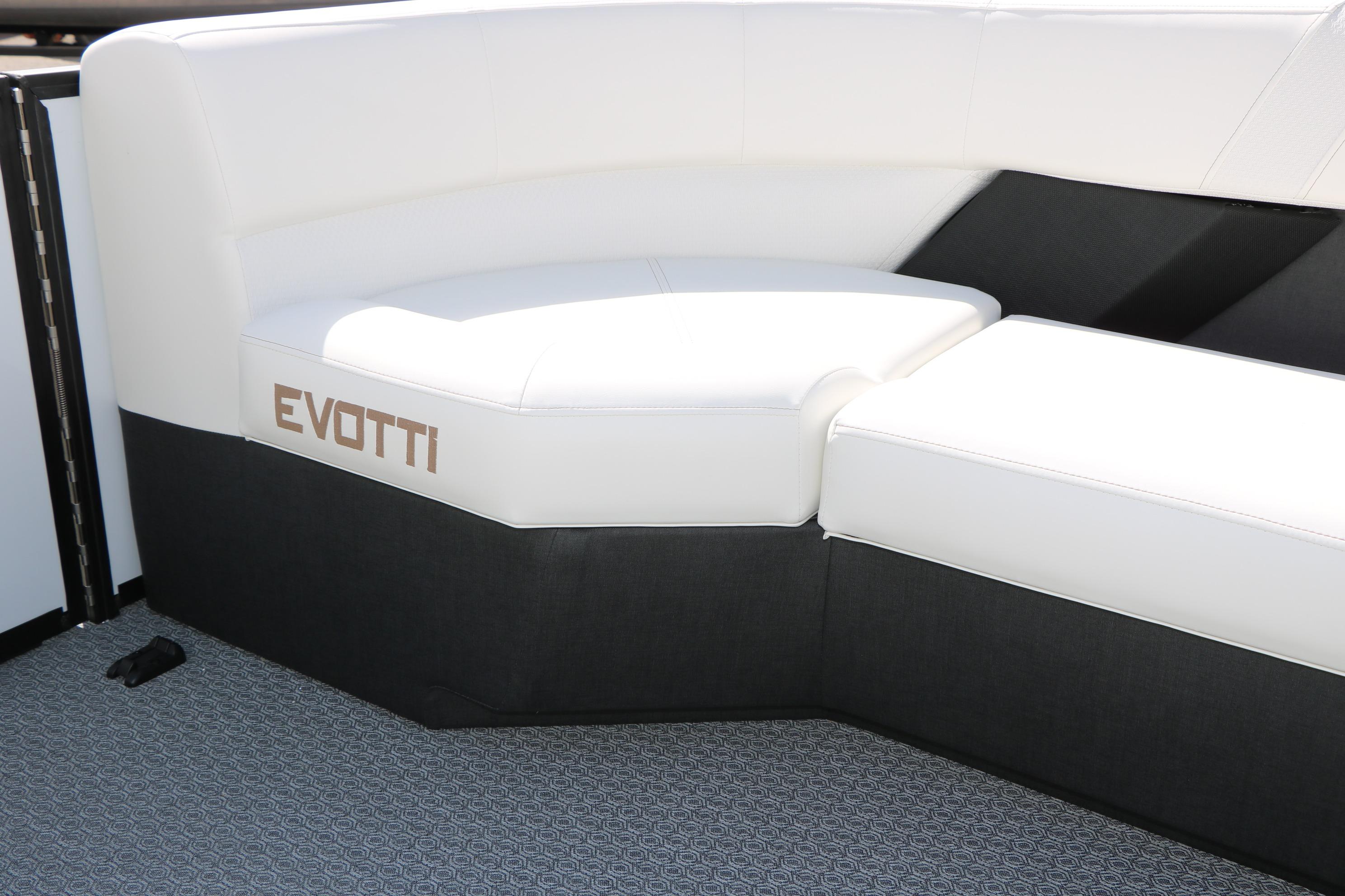 Luxurious seating on the 2026 Evotti 725 CS Tri-Toon boat, featuring sleek white and black upholstery.