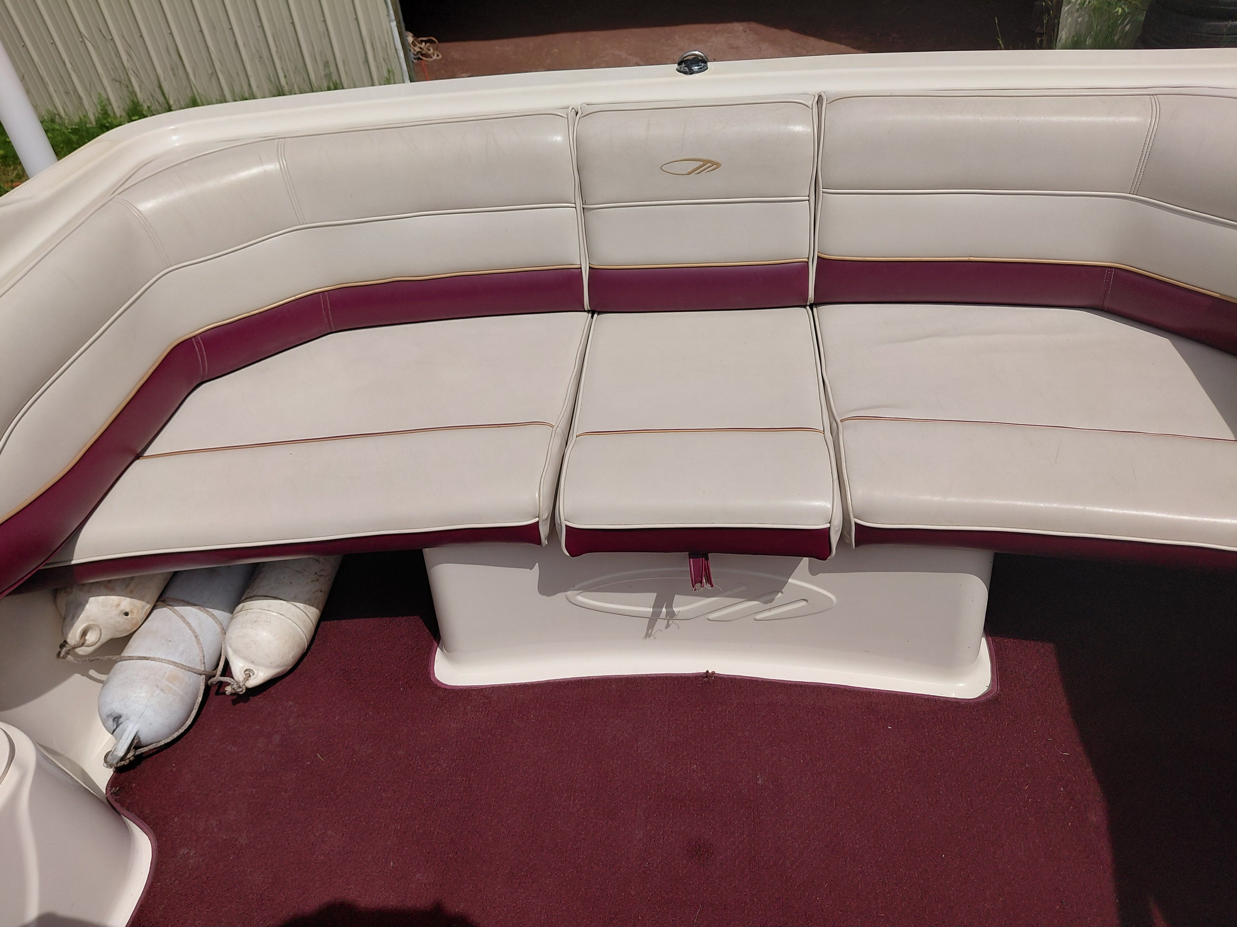 Interior view of a 1997 Maxum 2300 SC with cream and maroon upholstery.