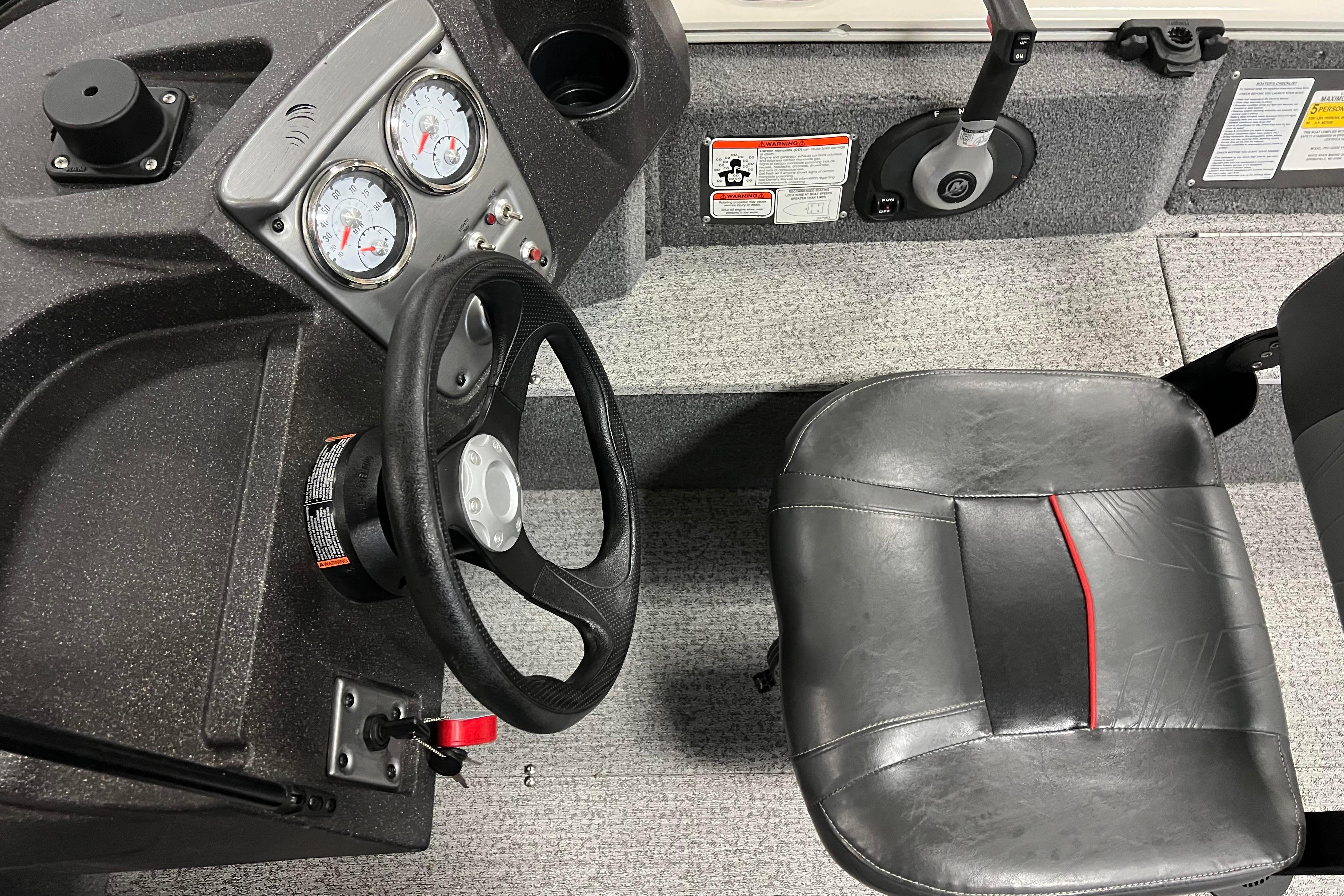 2022 Tracker Pro Guide V-16 WT boat interior with steering wheel and seat.