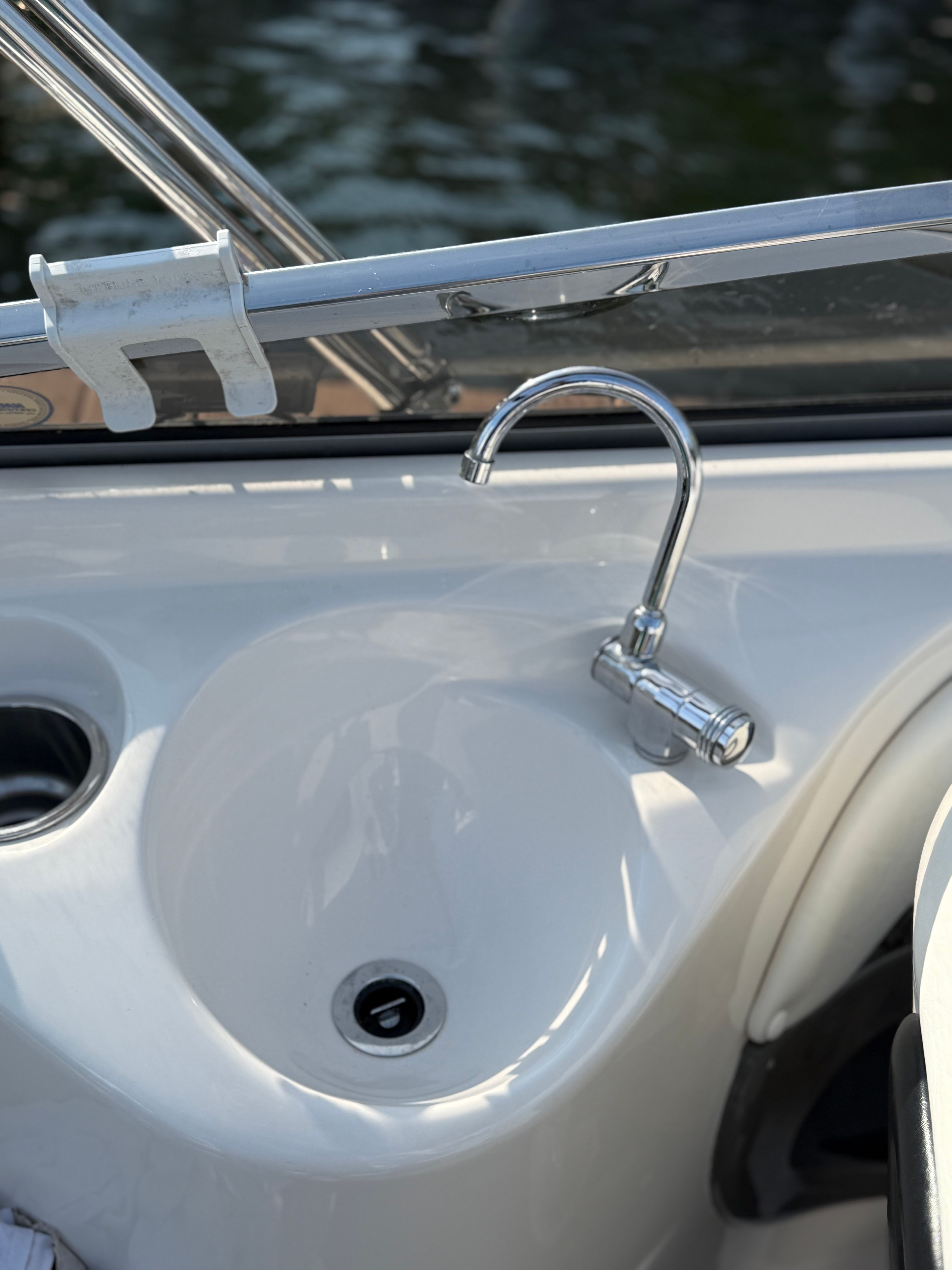 2007 Regal 2400 Bowrider boat sink with chrome faucet, close-up view.