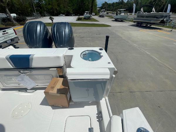 2023 Robalo R270 boat with twin engines and deck storage.