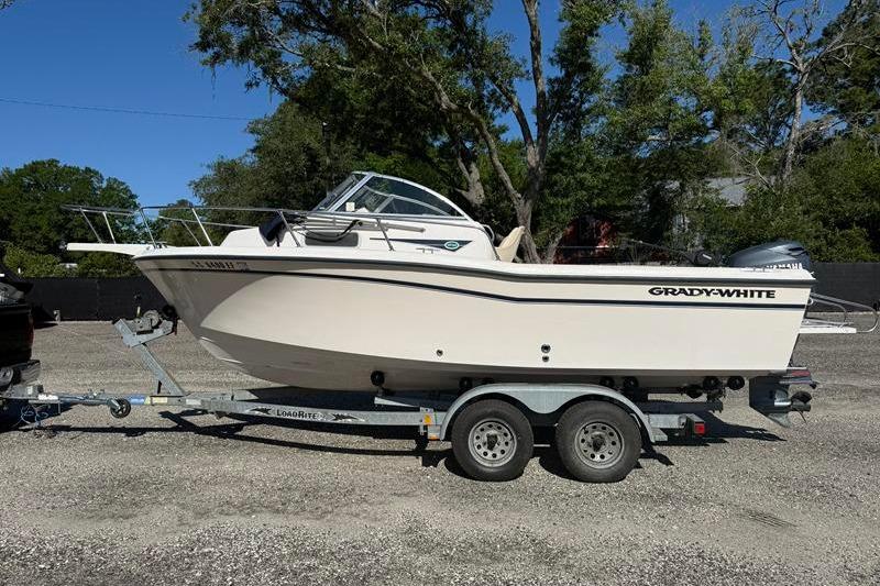 2001 Grady-White Adventure 208 boat on trailer, parked outdoors.