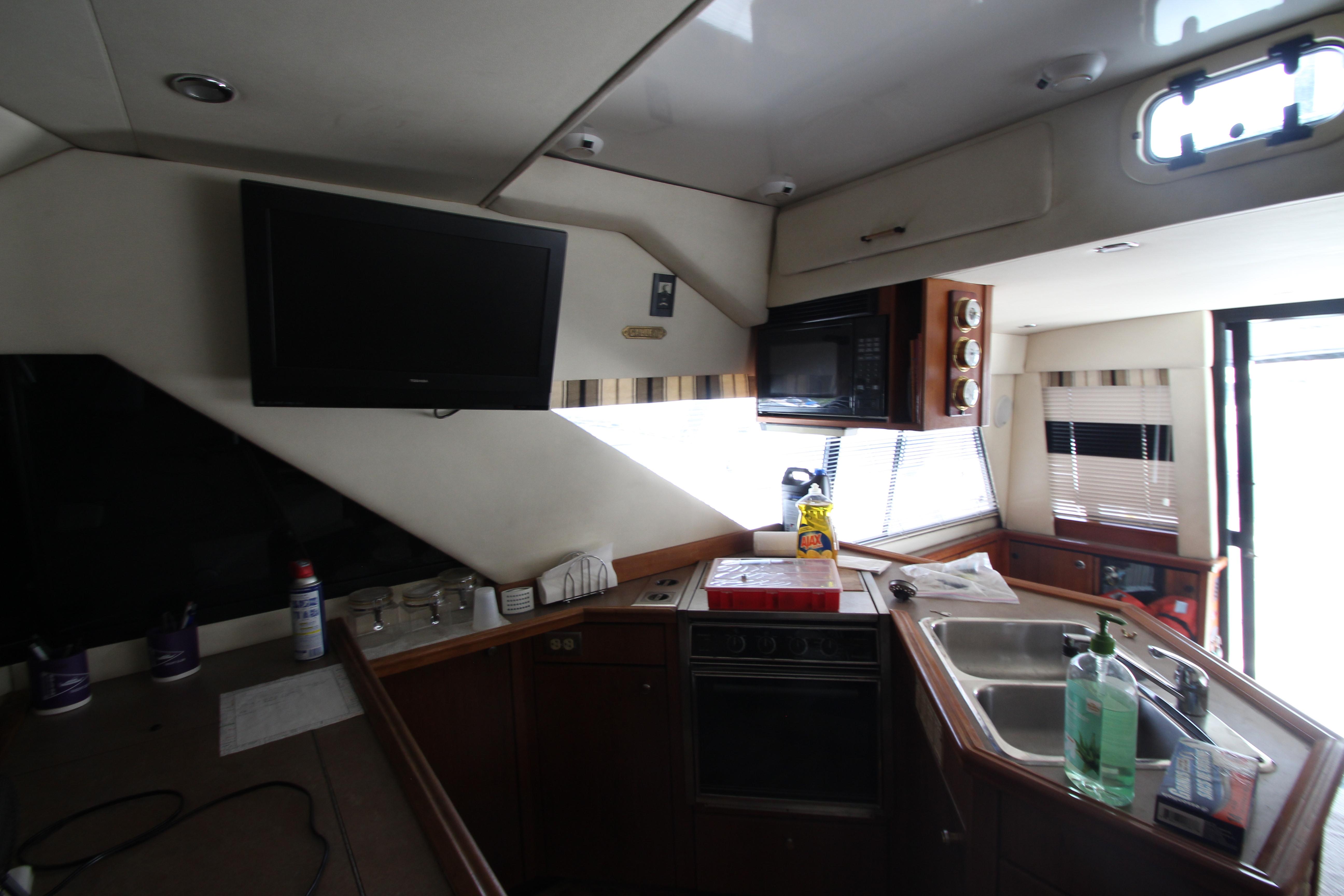 Interior of 1996 Bayliner 3988 Command Bridge Motoryacht kitchen with appliances and sink.