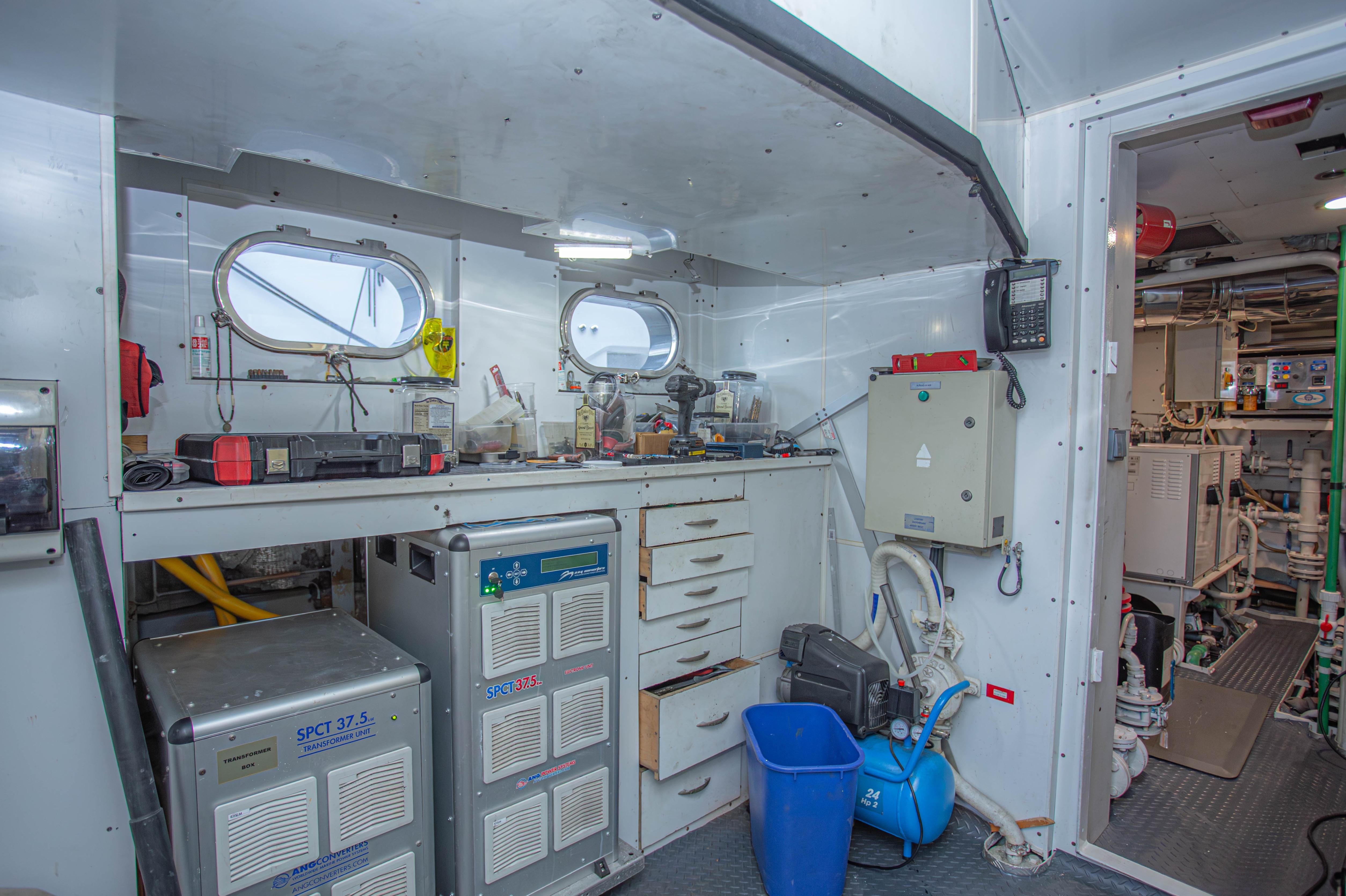 Engine room of 2014 Fifth Ocean Yachts 24m Explorer Yacht, featuring equipment and storage.