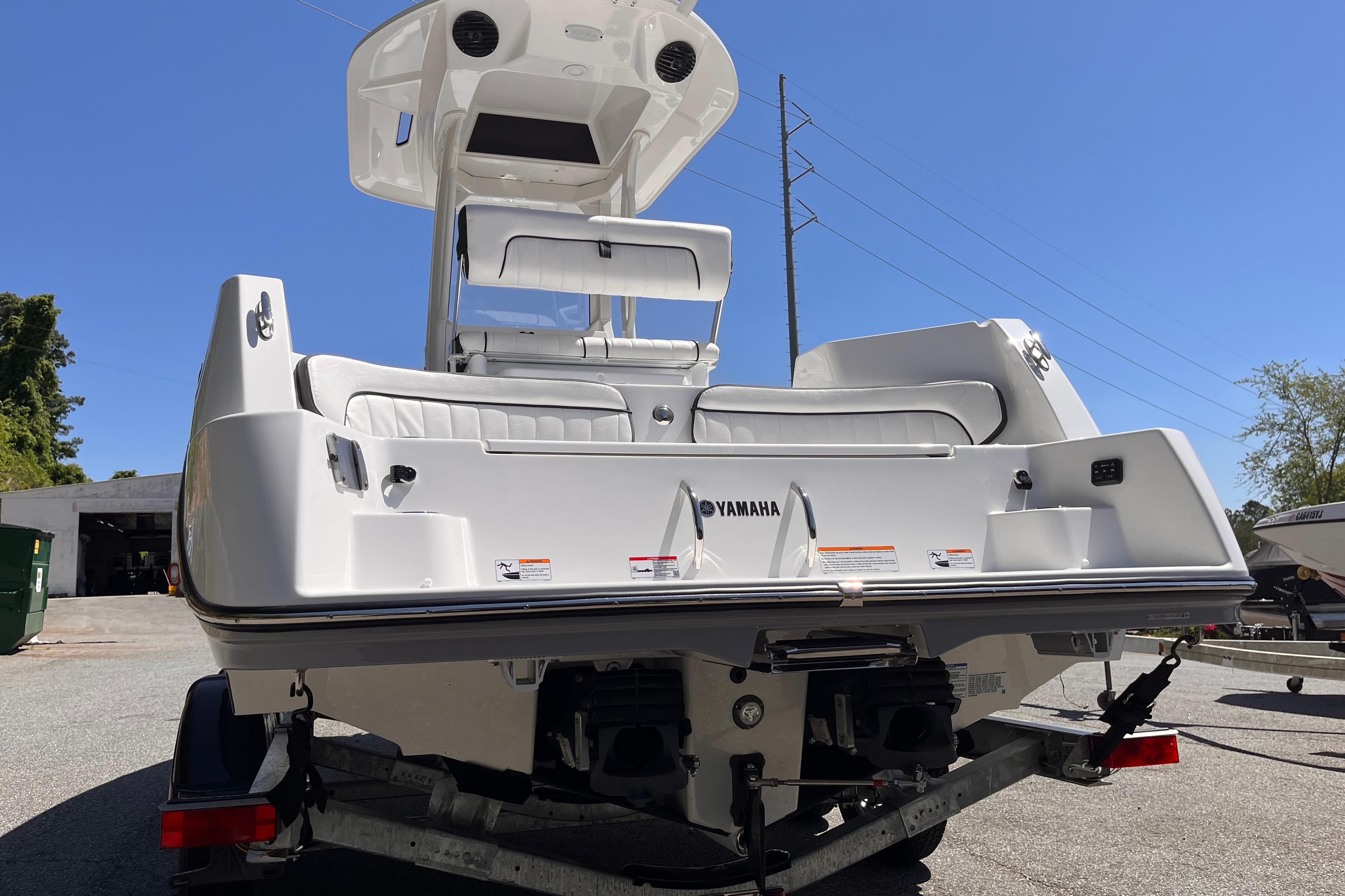 2026 Yamaha Boats 222 FSH Sport E on trailer, rear view under clear sky.