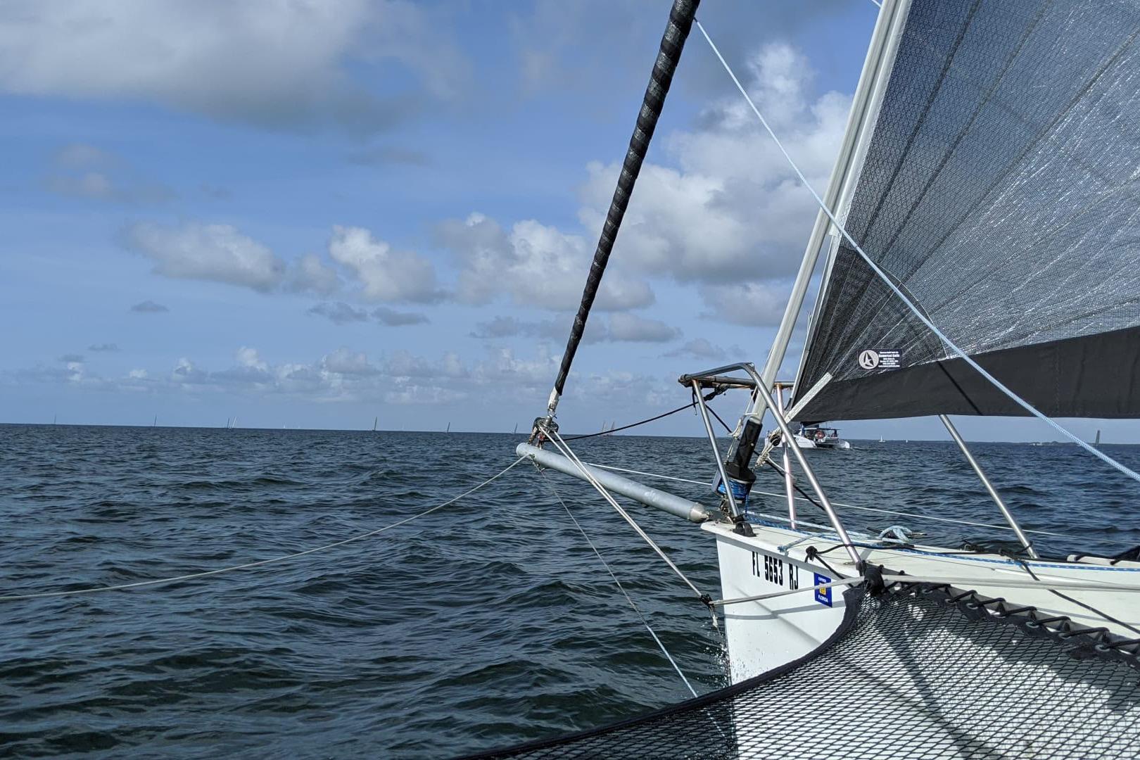 Sailing on a 1991 Corsair F-27 trimaran under clear skies and calm sea.