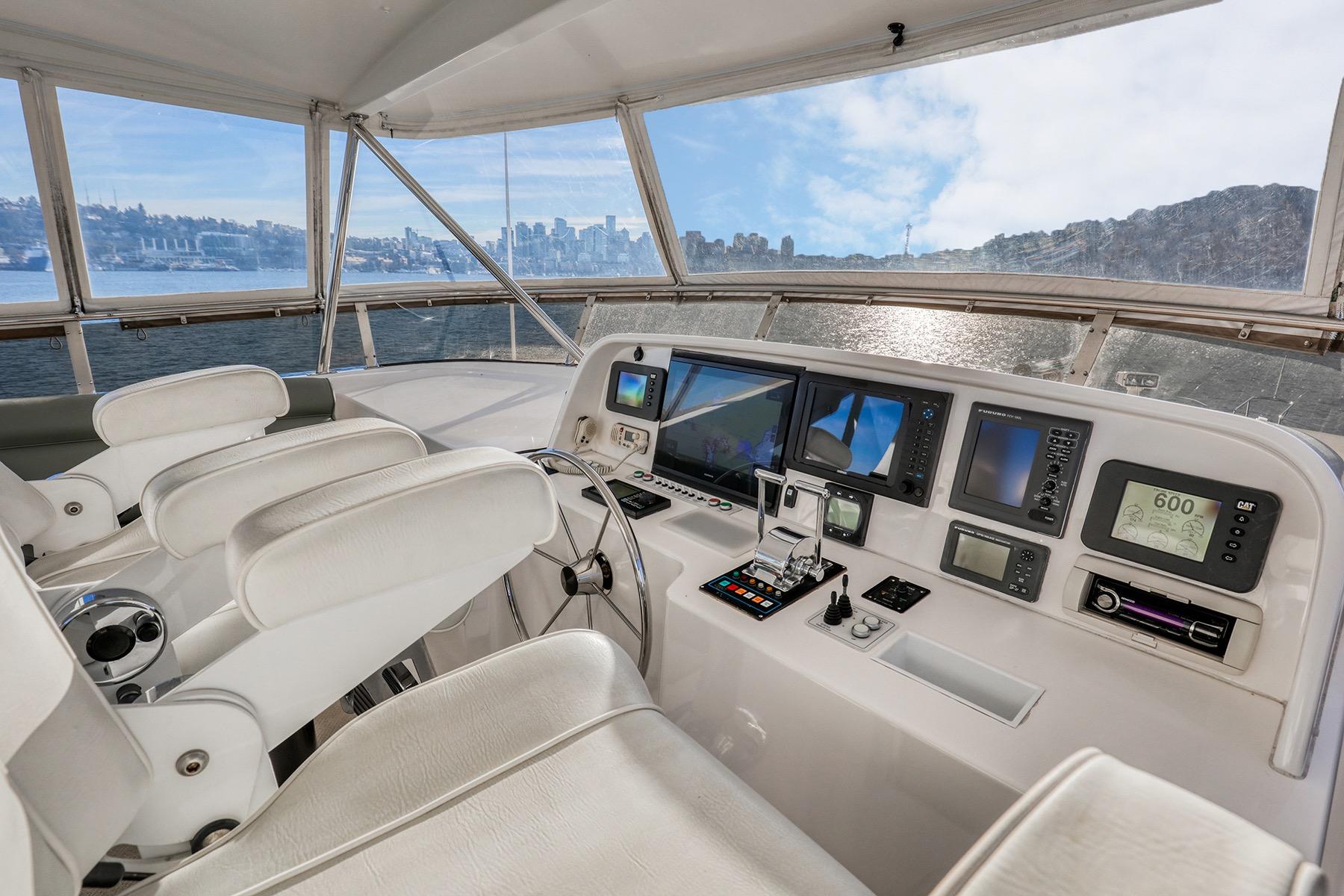 Helm of 2004 West Bay Sonship Motoryacht with modern navigation equipment and panoramic views.