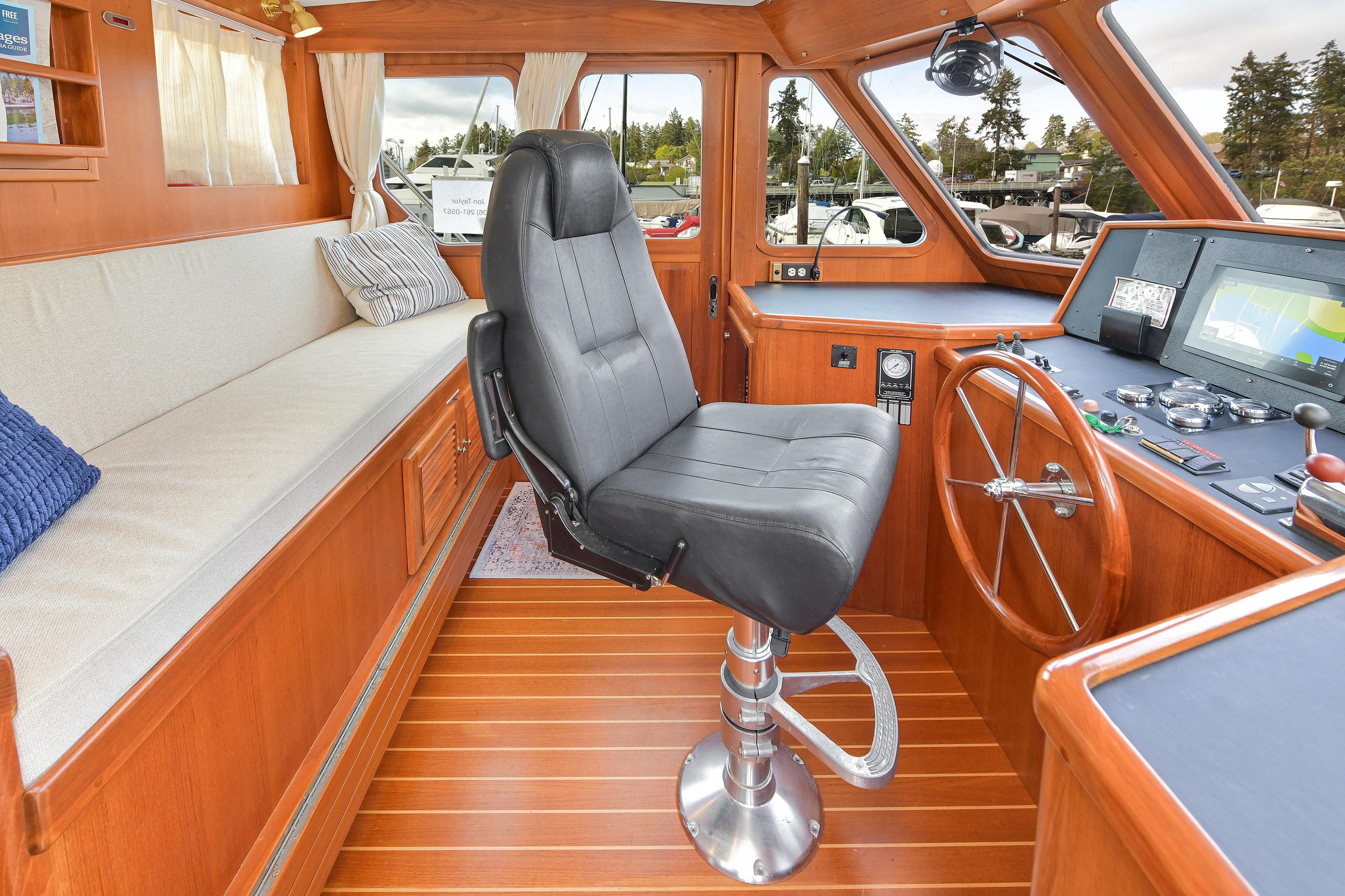 Pilothouse interior of 2010 North Pacific NP43, featuring helm seat and navigation controls.