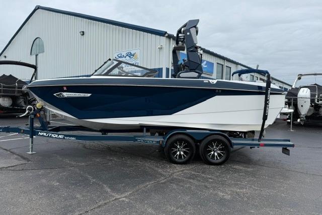2022 Nautique Super Air Nautique G21 boat on trailer, parked outside a marine dealership.
