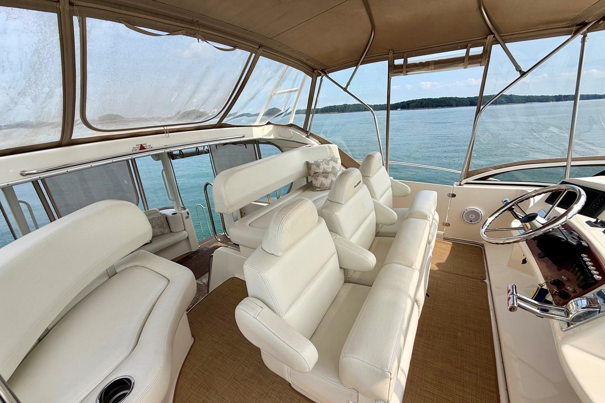 2004 Silverton 39 Motor Yacht interior with white seating and panoramic water view.
