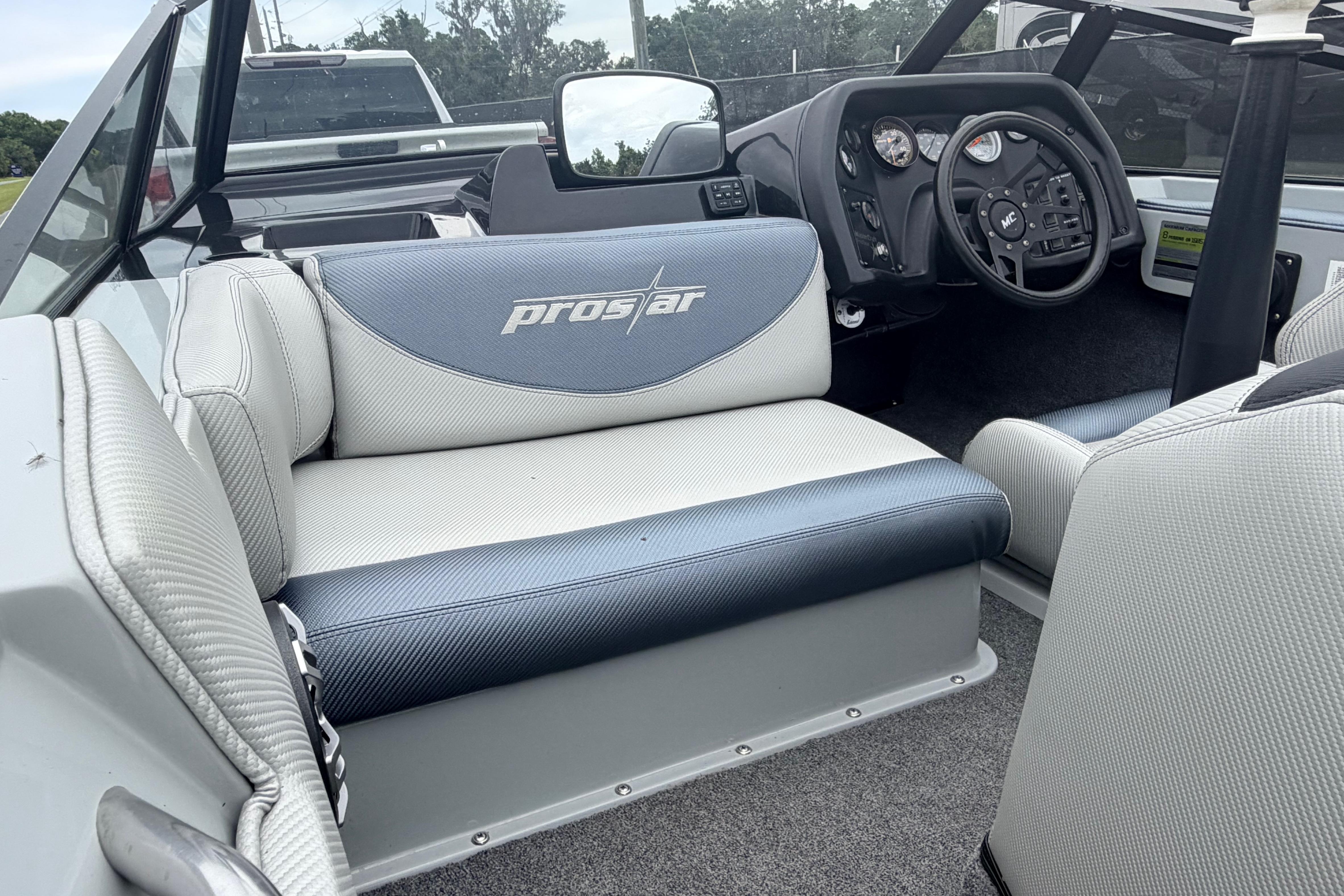 1989 MasterCraft ProStar 190 interior with steering wheel and seating, showcasing classic design.