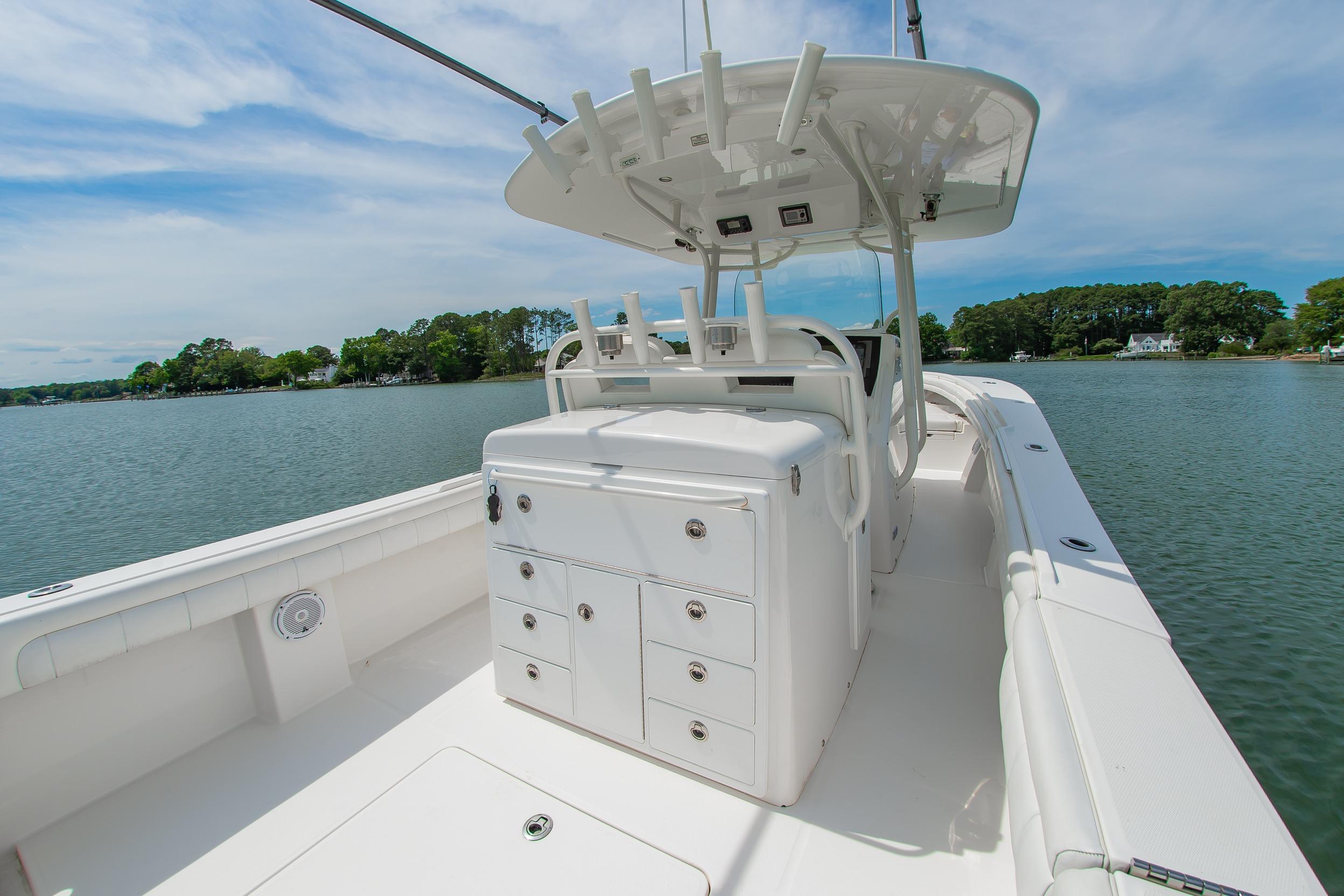 2019 Regulator 31 boat with center console on calm water, featuring ample storage and seating.