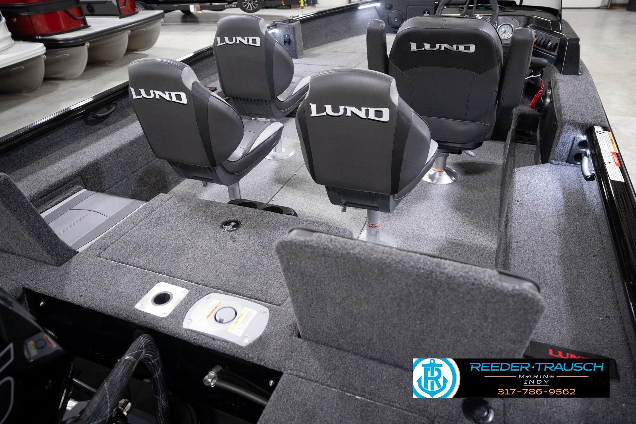 2026 Lund 1775 Impact XS SS boat interior with four seats and carpeted flooring.