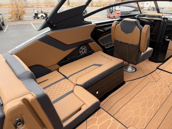 2025 Yamaha Boats 255XD interior with luxurious tan and black seating, modern design.