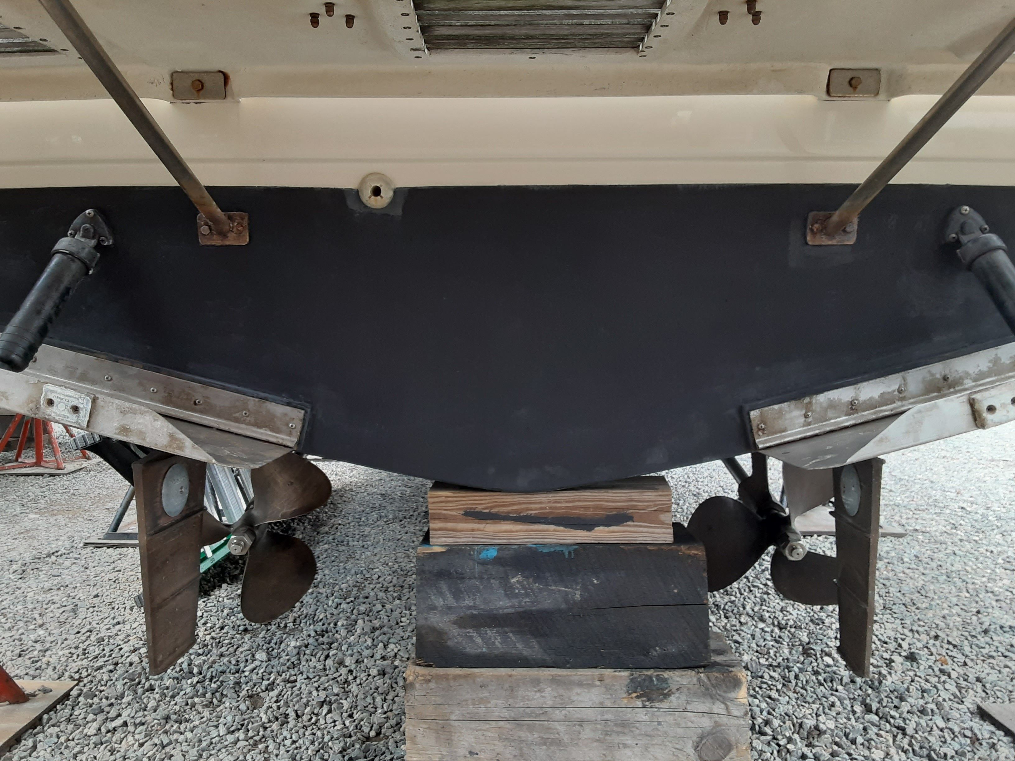 Rear view of a 1985 Tiara Yachts 3100 Open on a wooden block.