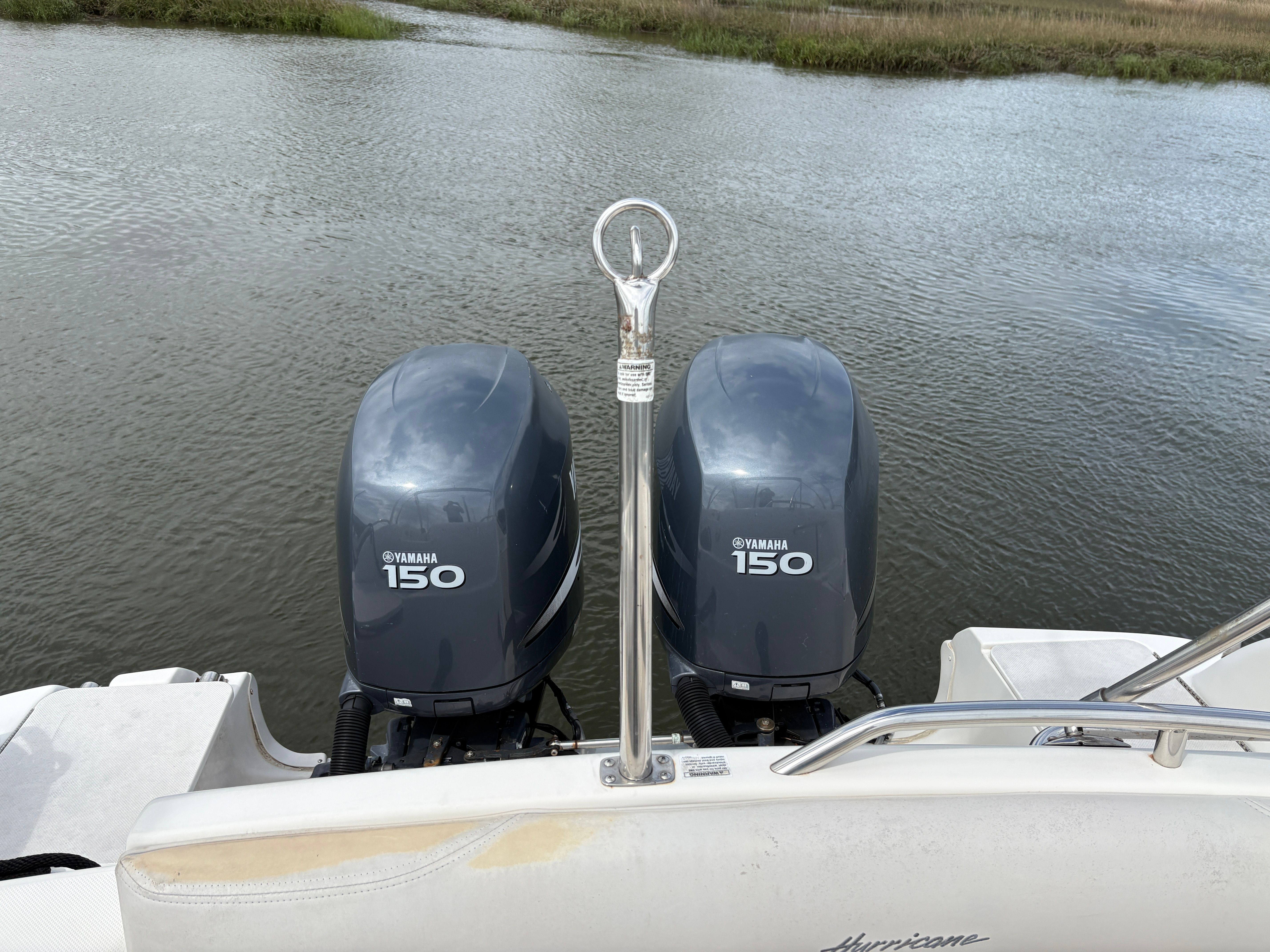 2009 Hurricane SUN DECK 260 with Yamaha 150 engines on calm water.
