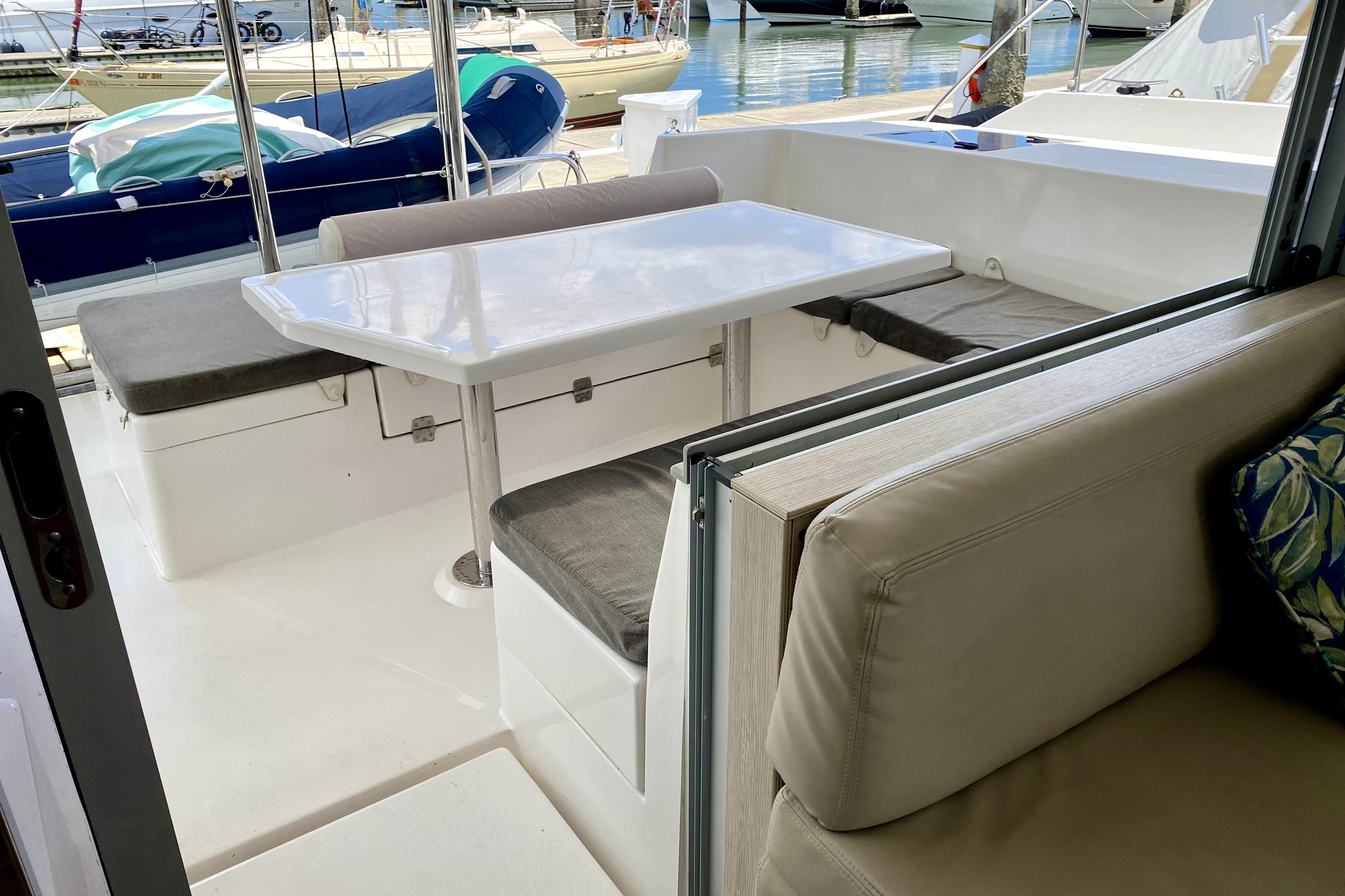 Interior view of a 2017 Leopard 40 catamaran with seating and table in the cockpit area.
