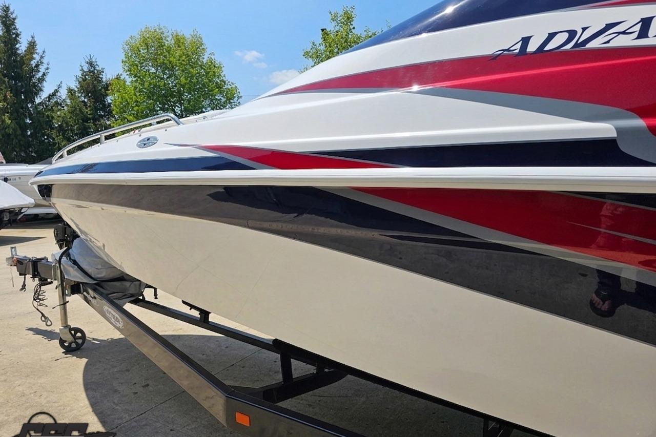 2019 Advantage 25 Citation Bowrider boat with sleek red, white, and blue design on trailer.