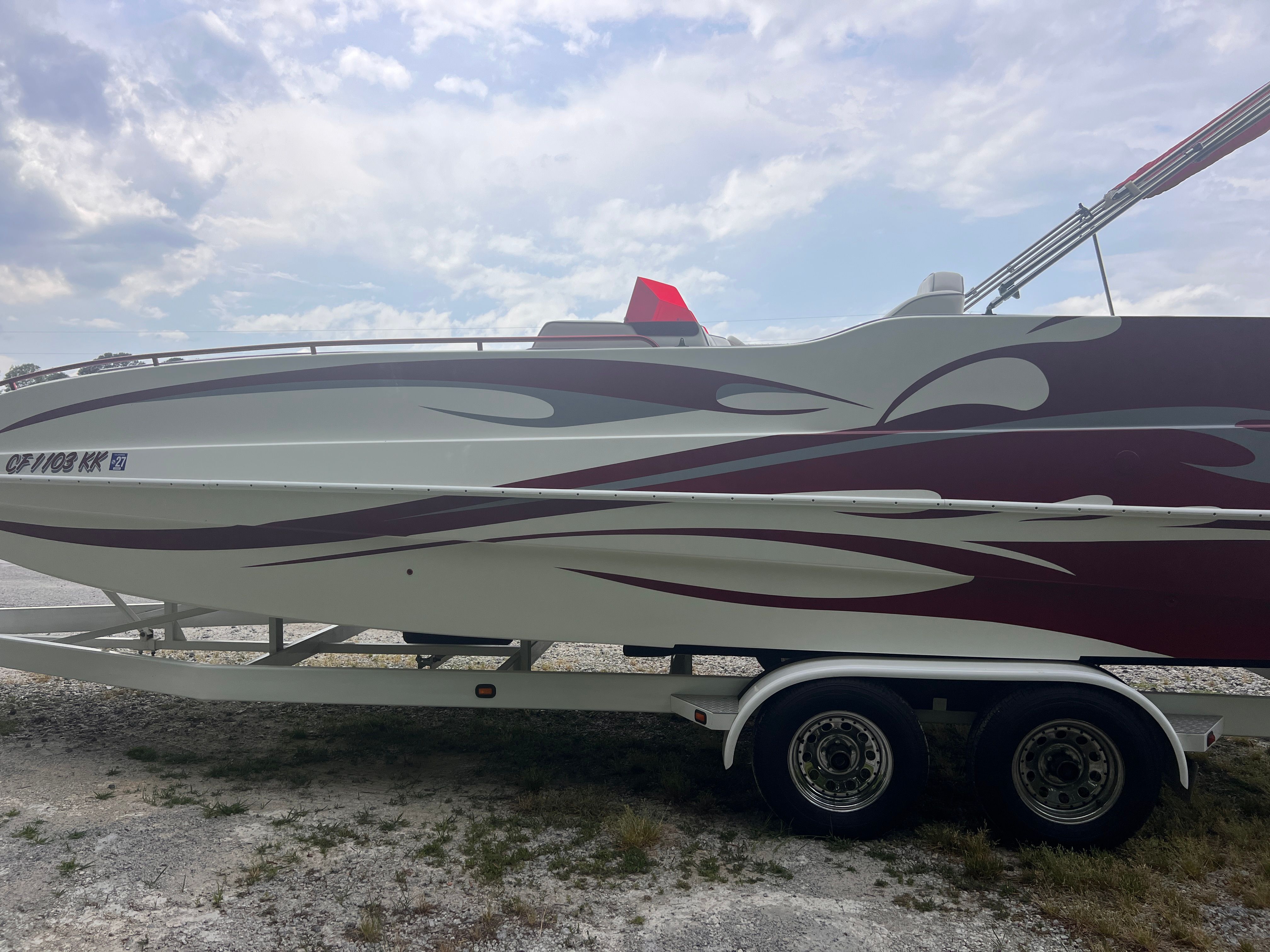 A 2008 Cheetah Fastcat on a trailer, featuring stylish red and white stripes.