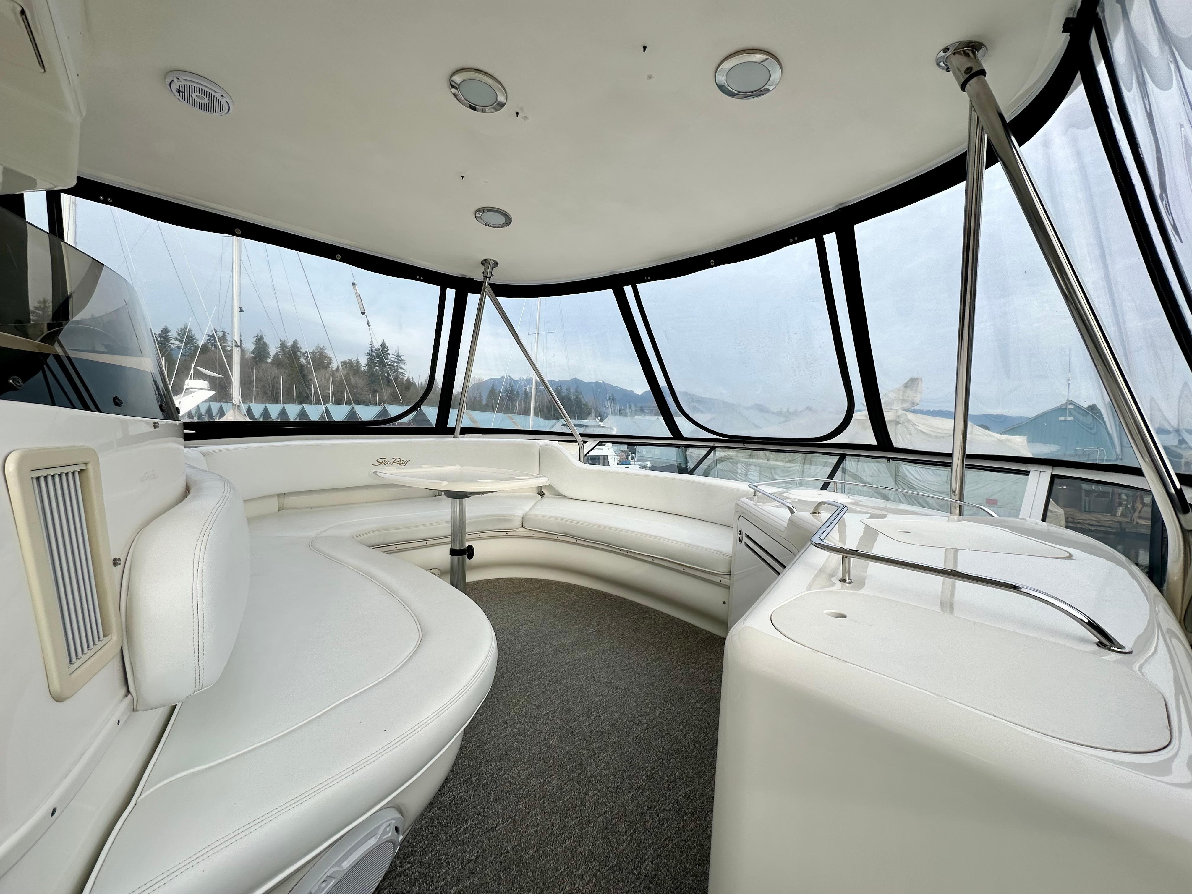 Luxurious interior of 2002 Sea Ray 560 Sedan Bridge yacht with panoramic windows.