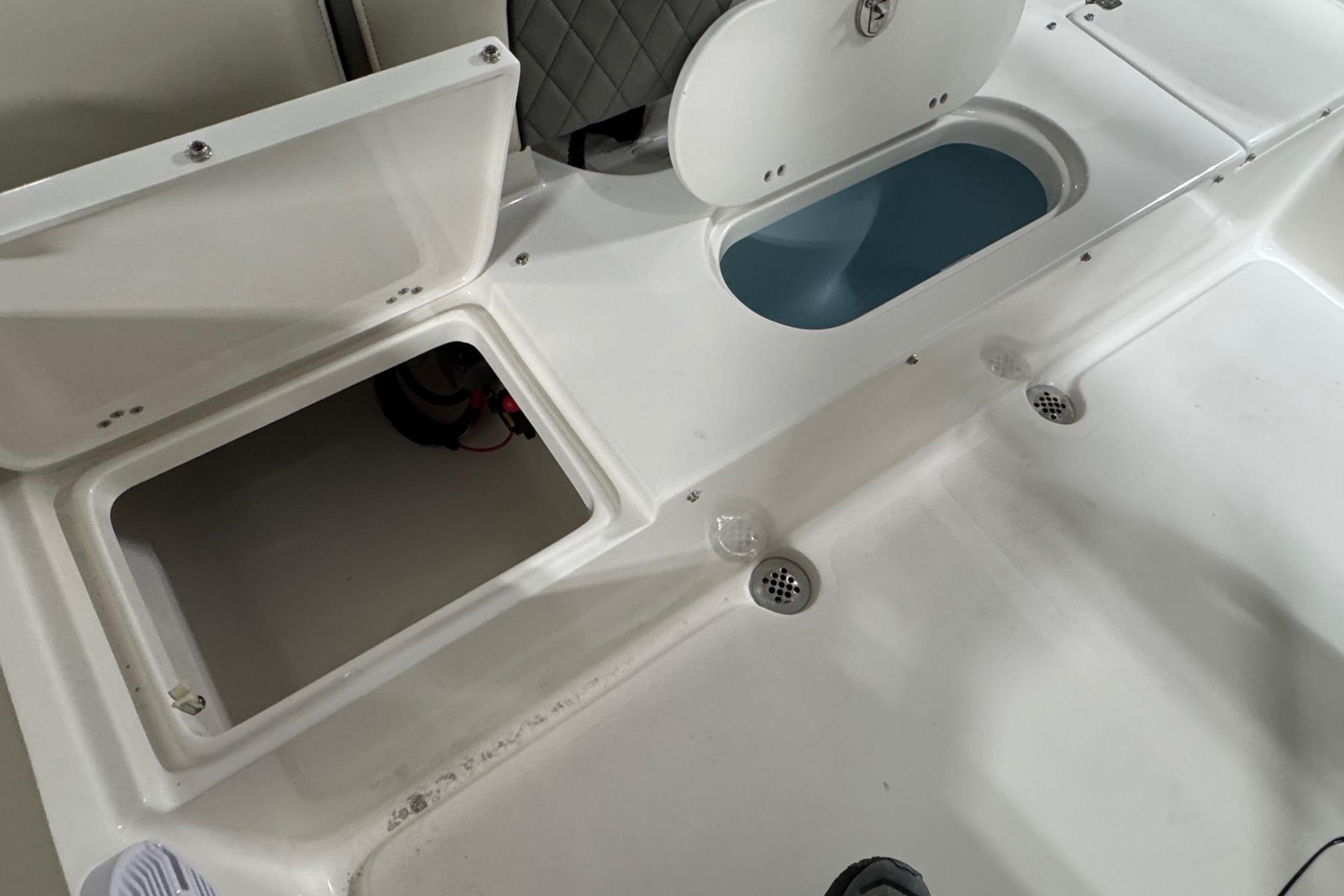 Open storage compartments on a 2026 Key West 203 FS boat deck.
