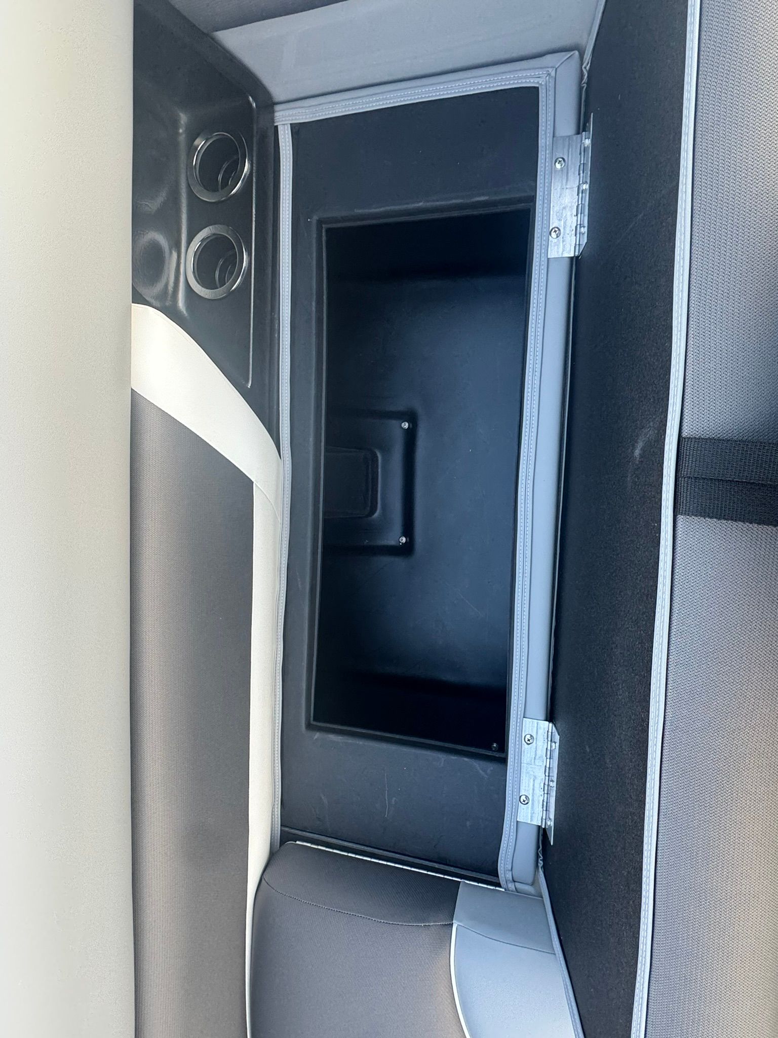 Interior of 2026 Landau 23 Island Breeze with storage compartment.