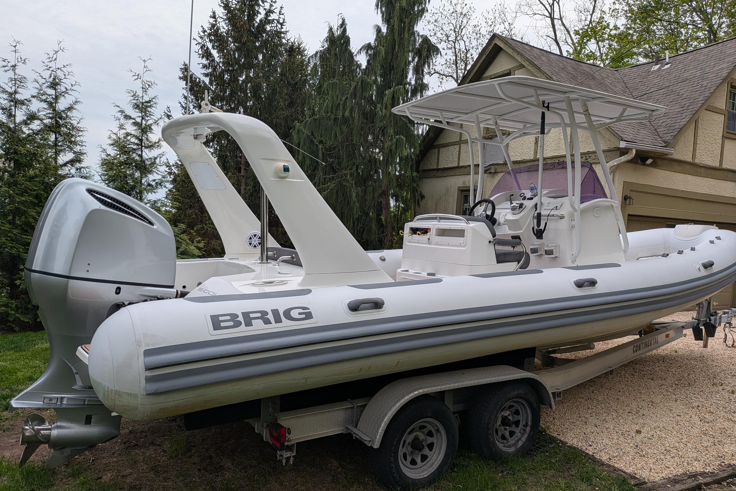 2016 Brig E780 boat on trailer, parked near a house, featuring sleek design and powerful engine.