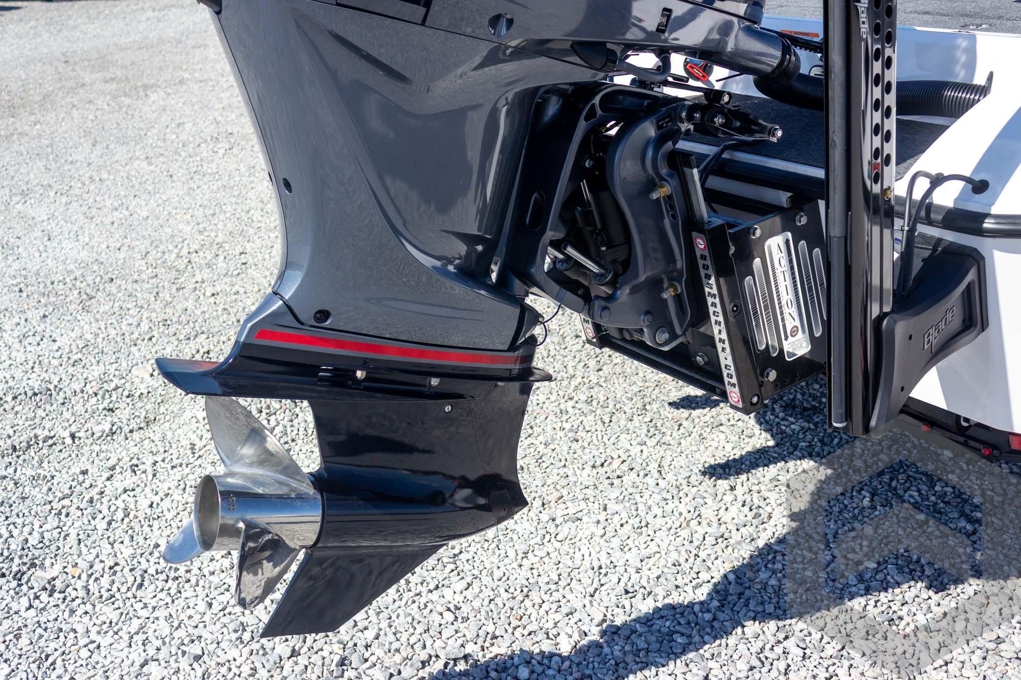 2026 Vexus VXs20 boat motor and propeller on gravel surface.