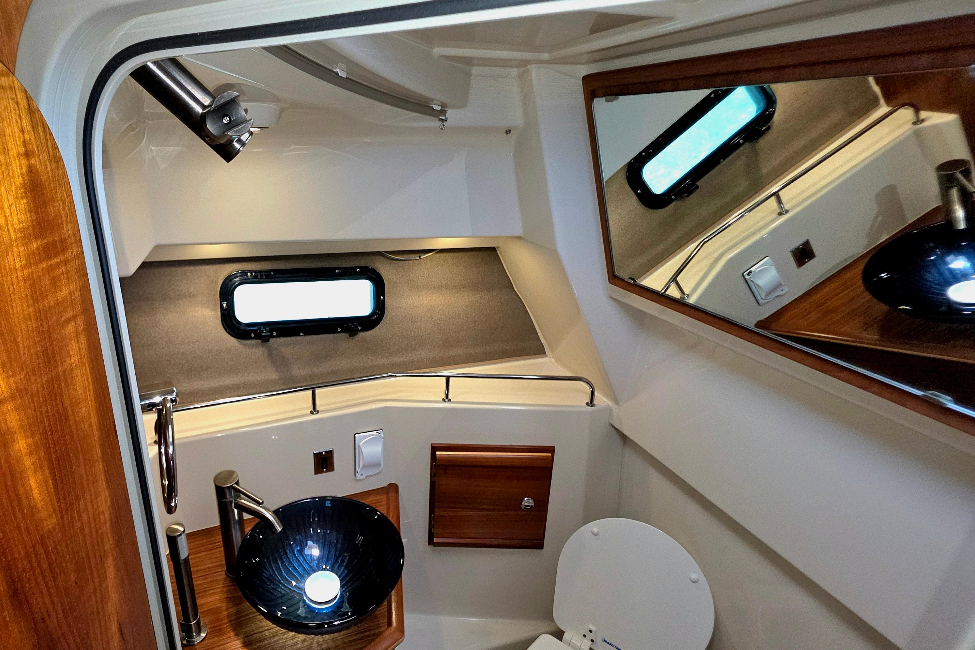 2021 Ranger Tug R27 bathroom interior with modern fixtures and mirror.