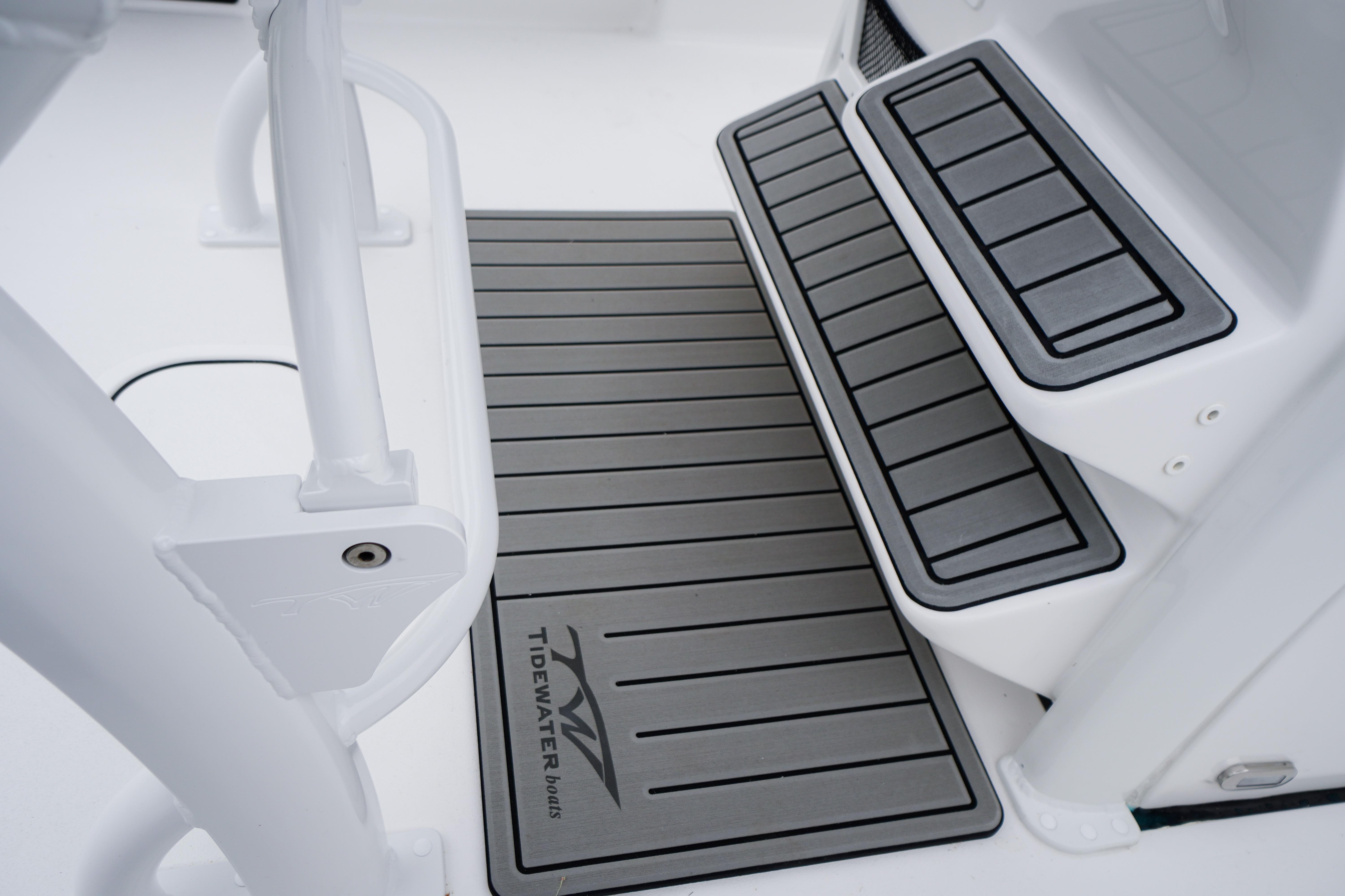 2026 Tidewater 232 SS boat interior with non-slip steps and branded mat.
