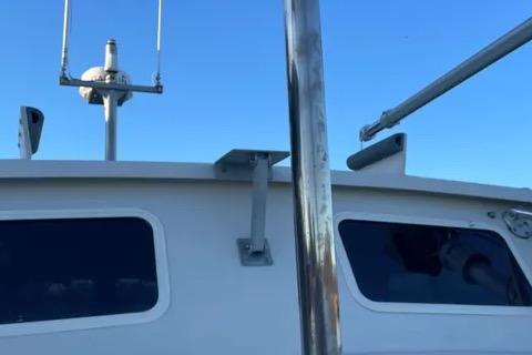 1997 Rosborough Trawler boat with radar equipment against a clear blue sky.