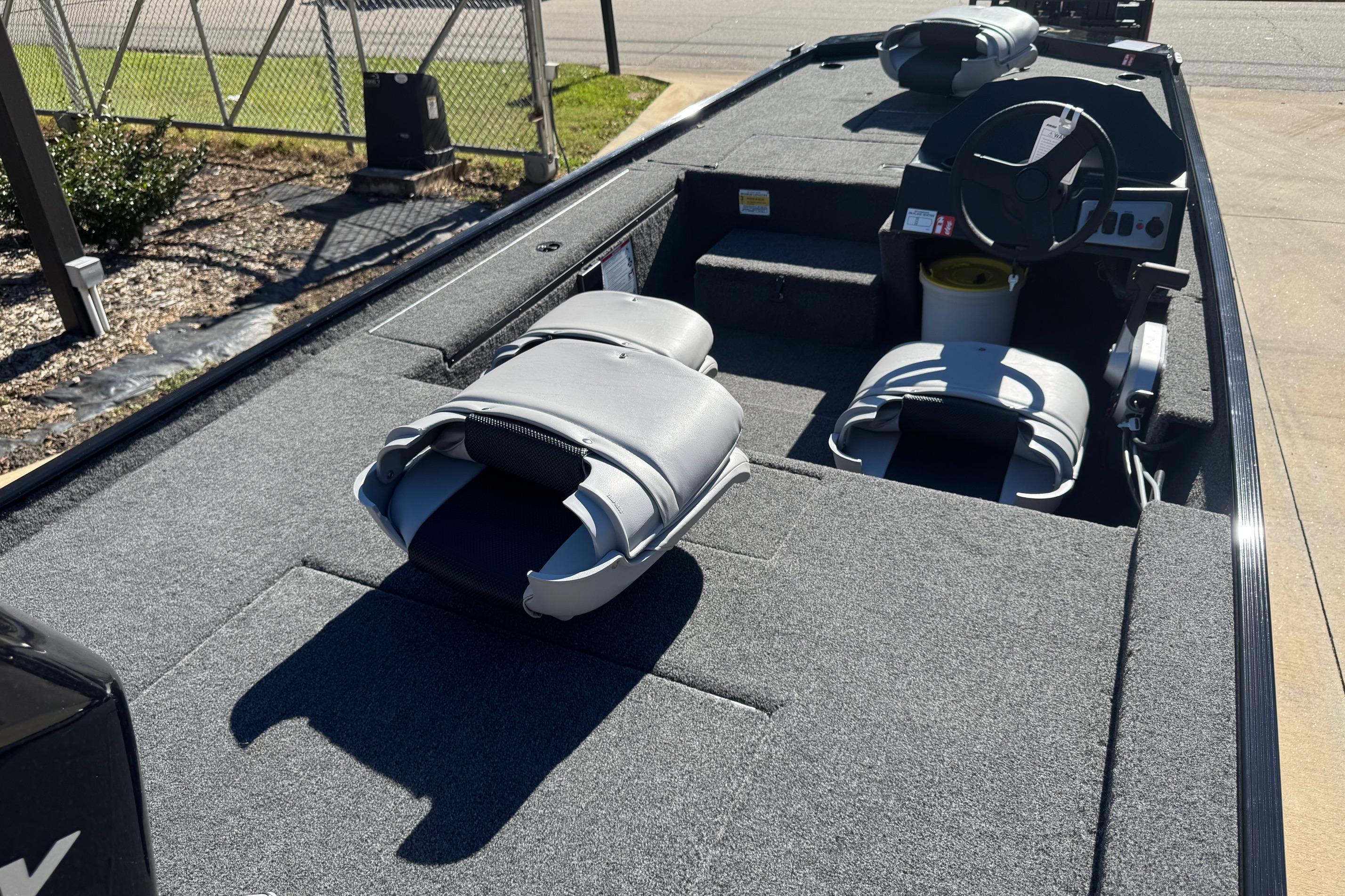 2026 Crestliner 1600 Storm boat interior with gray seating and steering console.