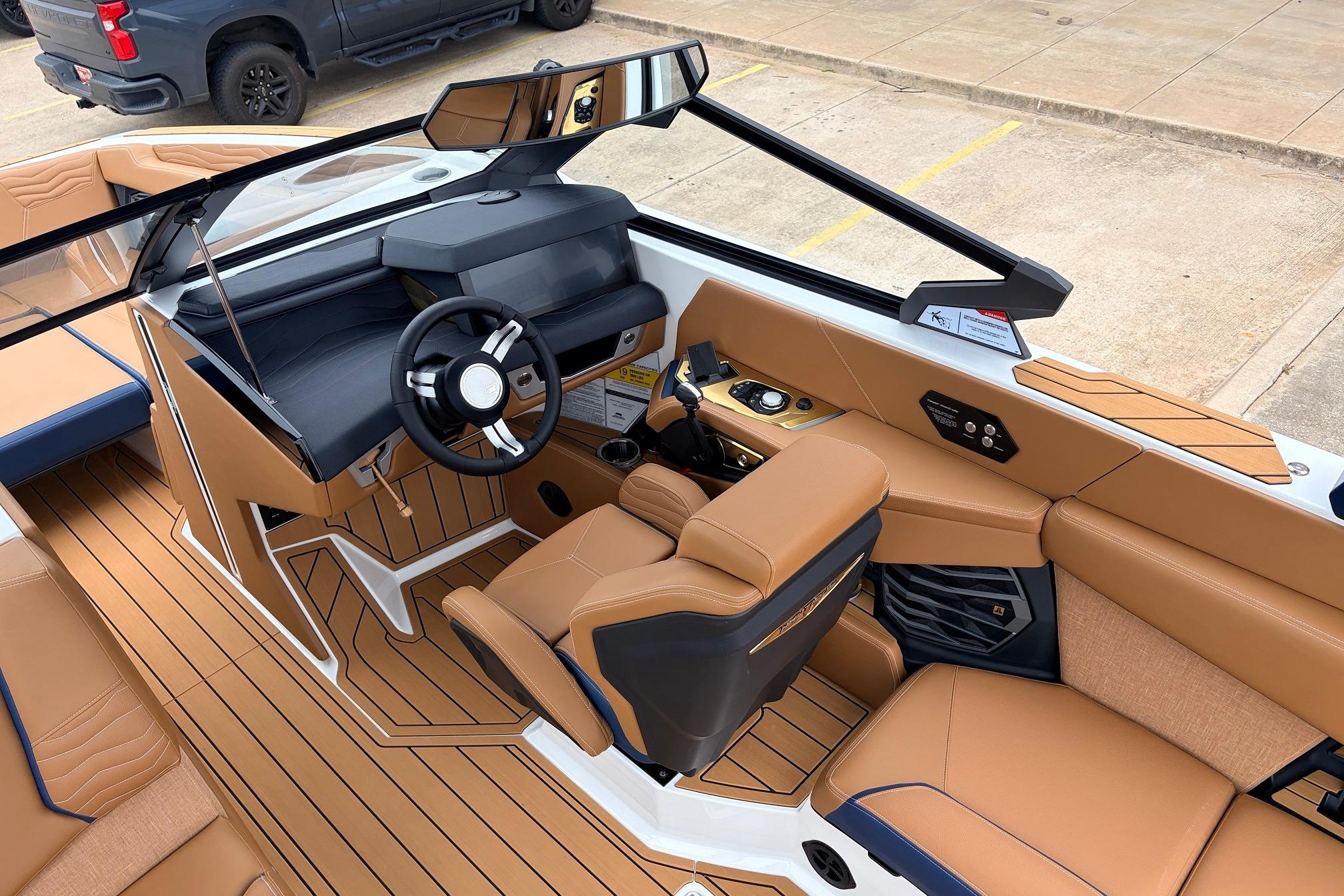 2026 Nautique Super Air Nautique G25 interior with tan upholstery and modern dashboard design.