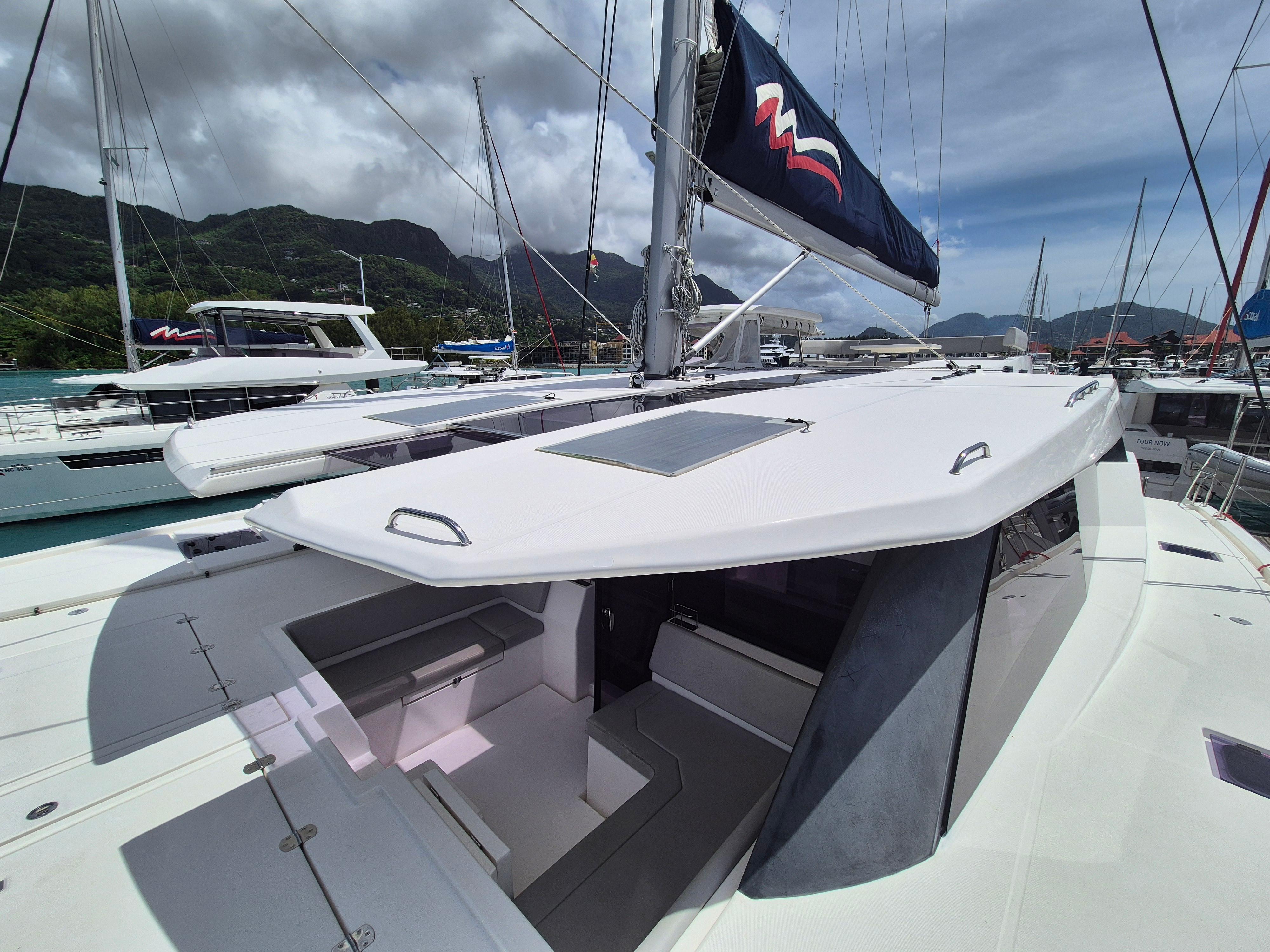Leopard 50 catamaran, 2020 model, docked with scenic mountain backdrop and clear skies.